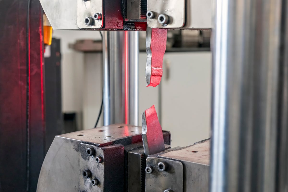 Tensile testing machine applying a controlled load to a specimen in a materials laboratory