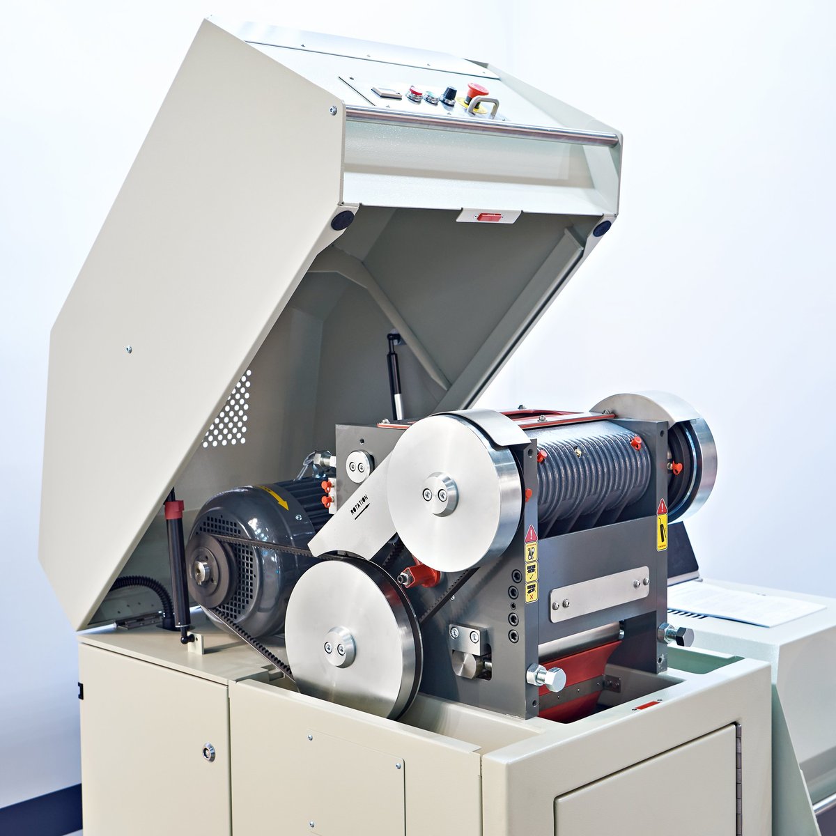 A laboratory jaw crusher with an attached rotating sample divider used to prepare a test portion.