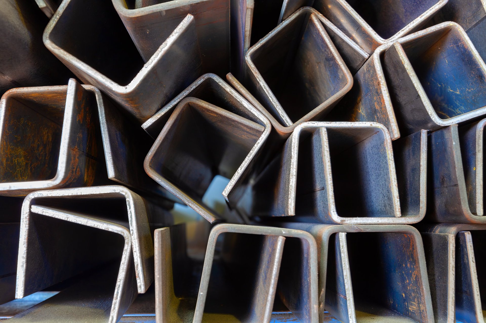 Racked steel profiles in a metal fabrication workshop, ready for cutting and assembly