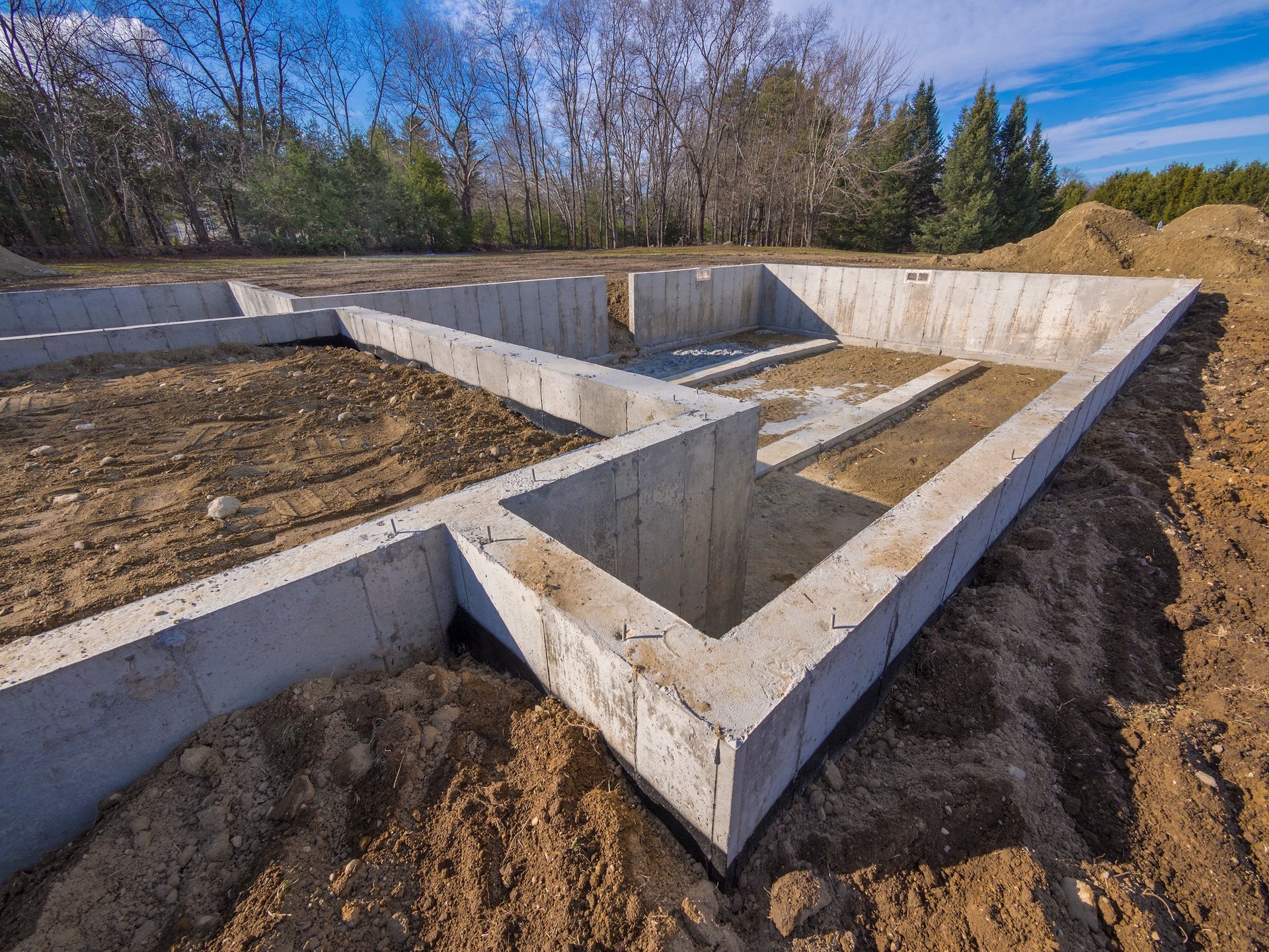 Concrete foundation strip under construction at a building site