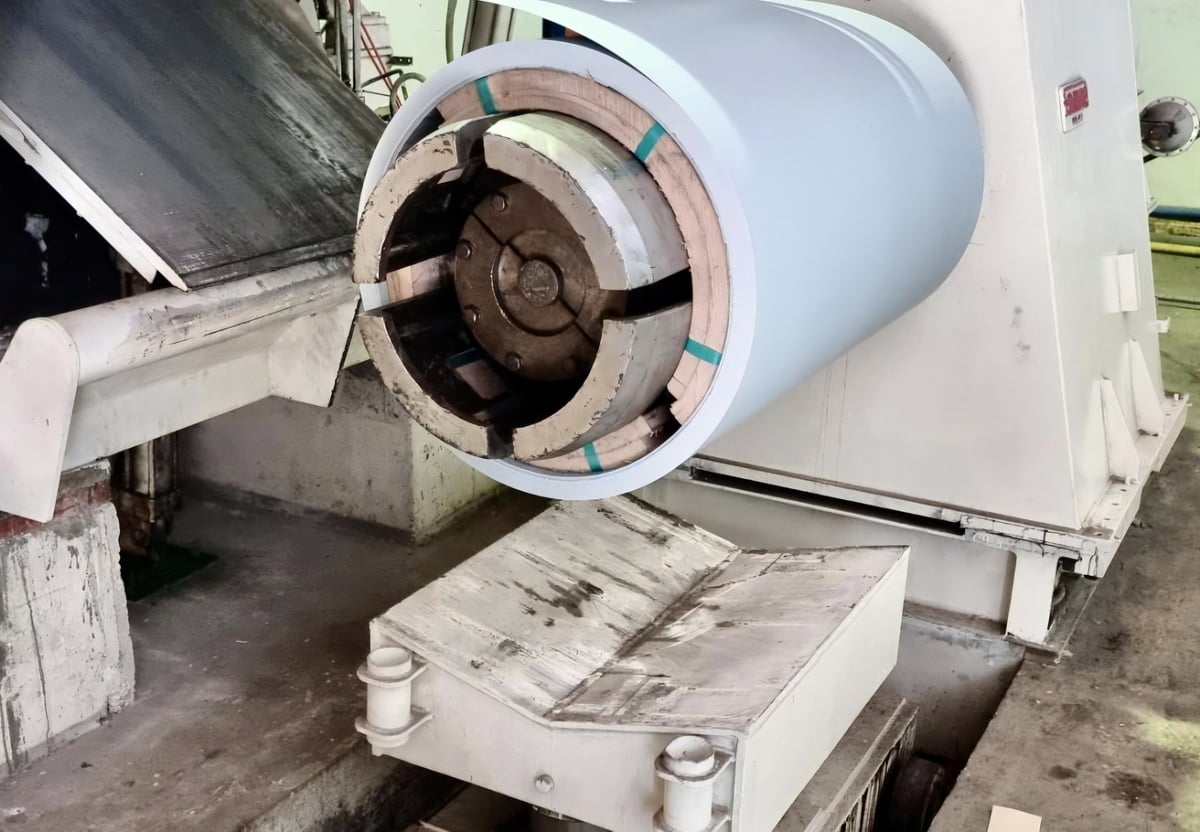 Sheet steel being processed on a machine in an industrial plant