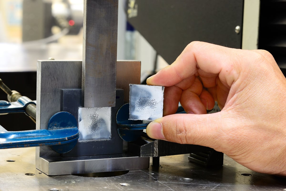 Prepared steel test specimen representing the mechanical evidence a grade qualification depends on
