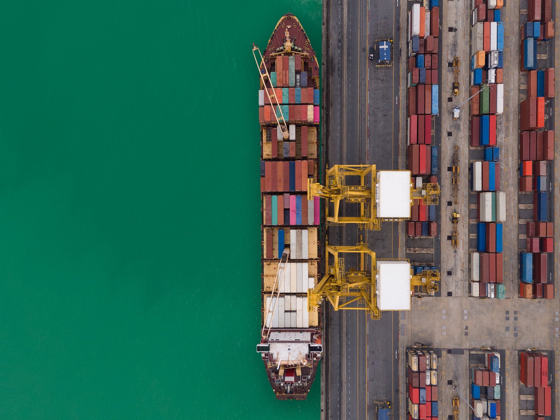 Aerial view of an import-export container port, representing a cross-border steel consignment