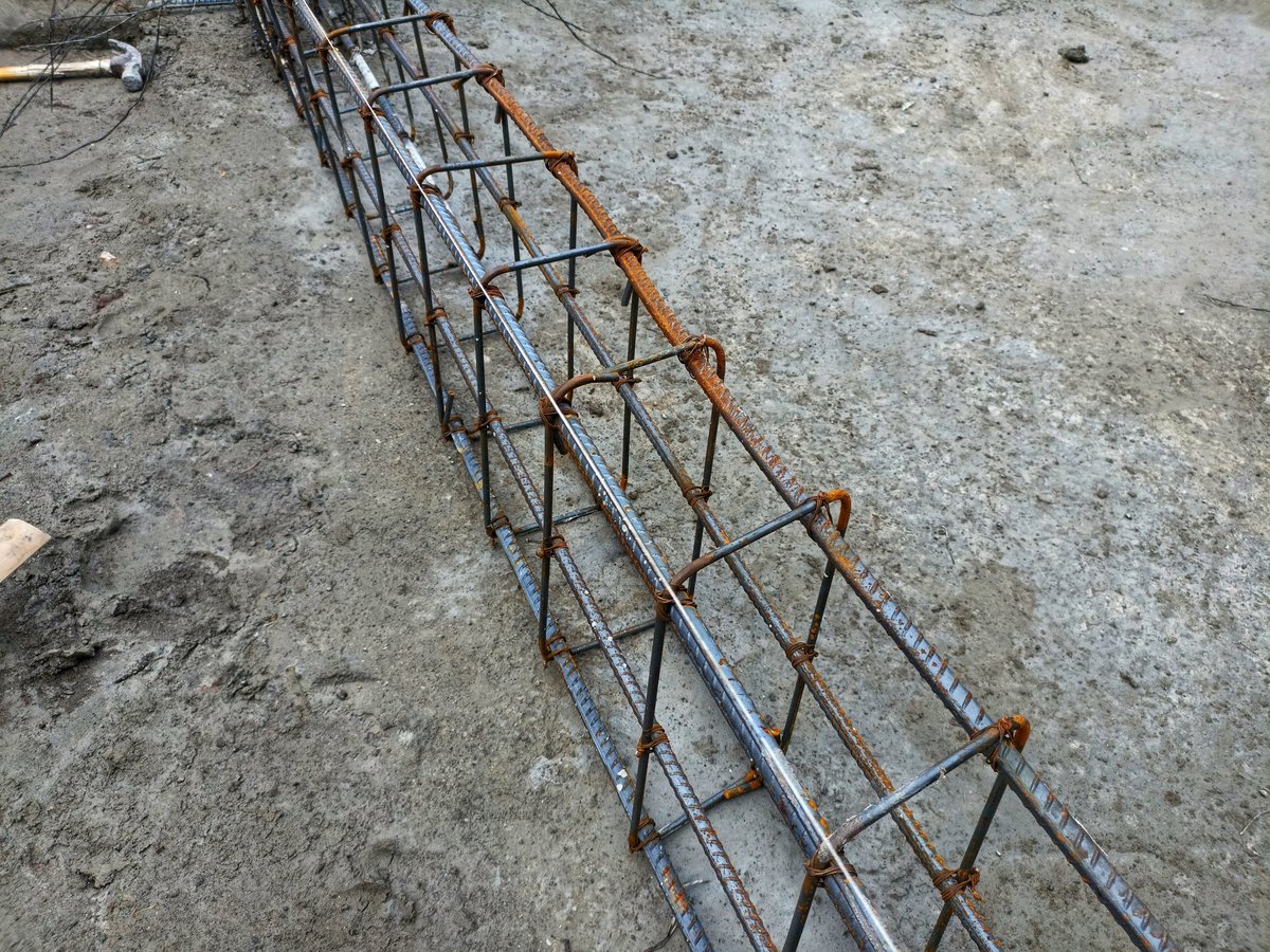 Reinforcement cage tied and assembled for a concrete element, showing the lap and continuity detailing where the specification route directly affects splice provisions.
