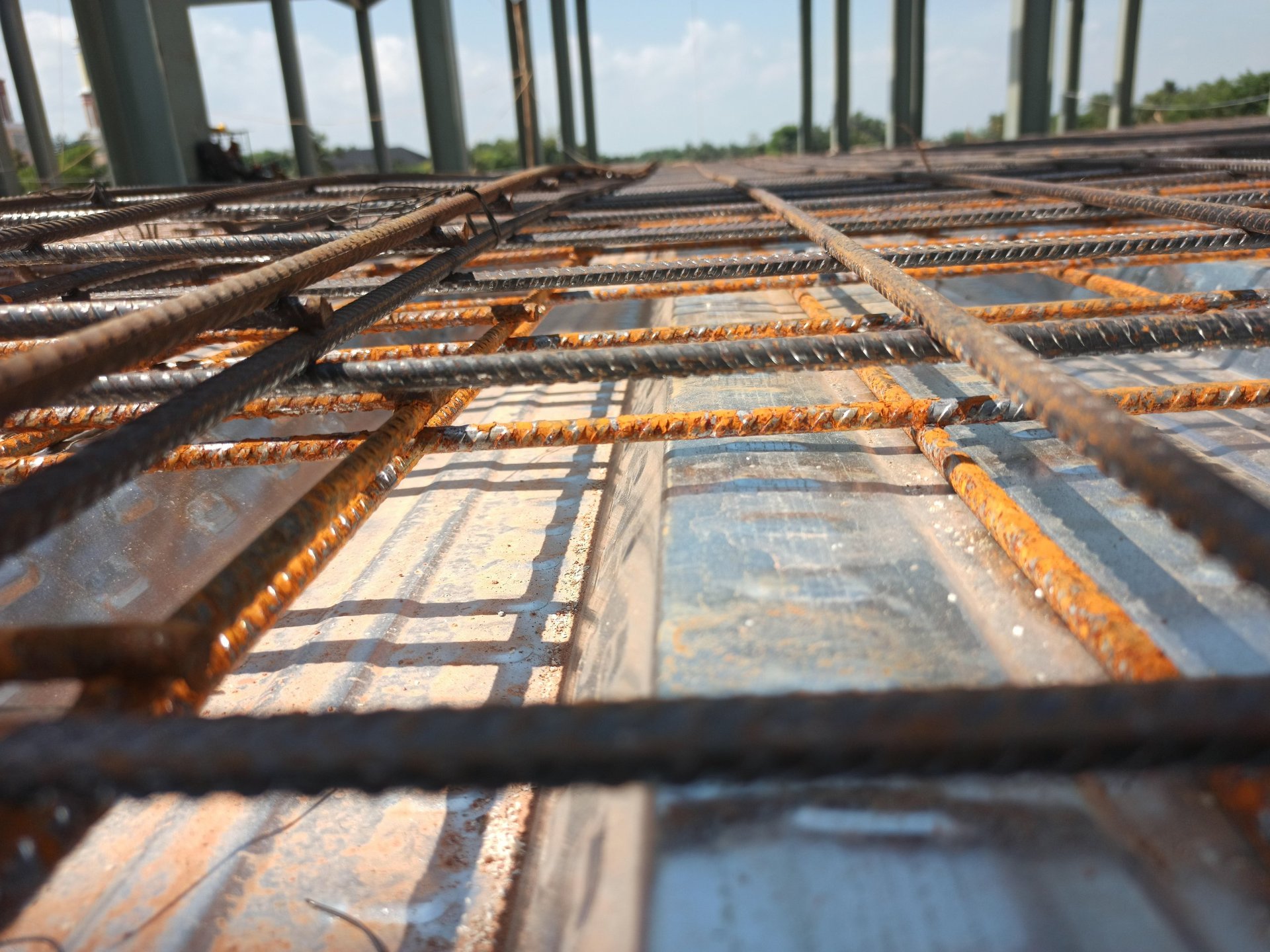 Steel rebar grid tied and ready for concrete placement at a construction site