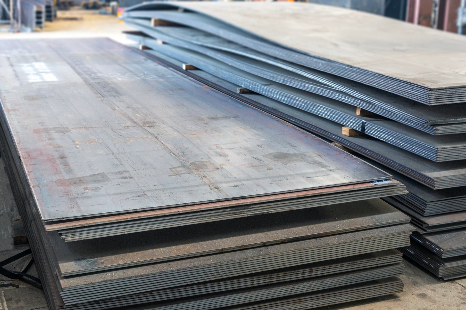 Carbon steel shipbuilding plates stacked in a steel yard