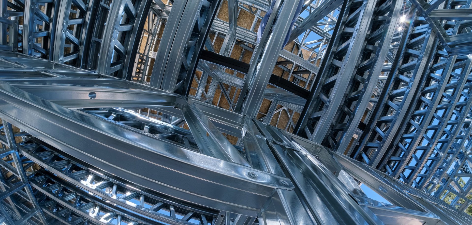 Steel frame members erected into a structural skeleton