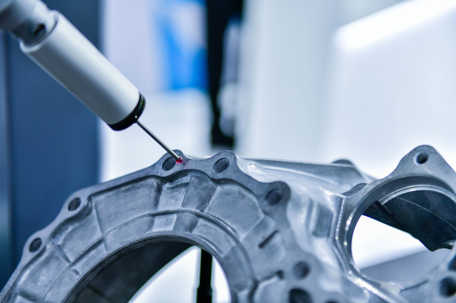 Coordinate measuring machine inspecting a machined metal component for dimensional accuracy