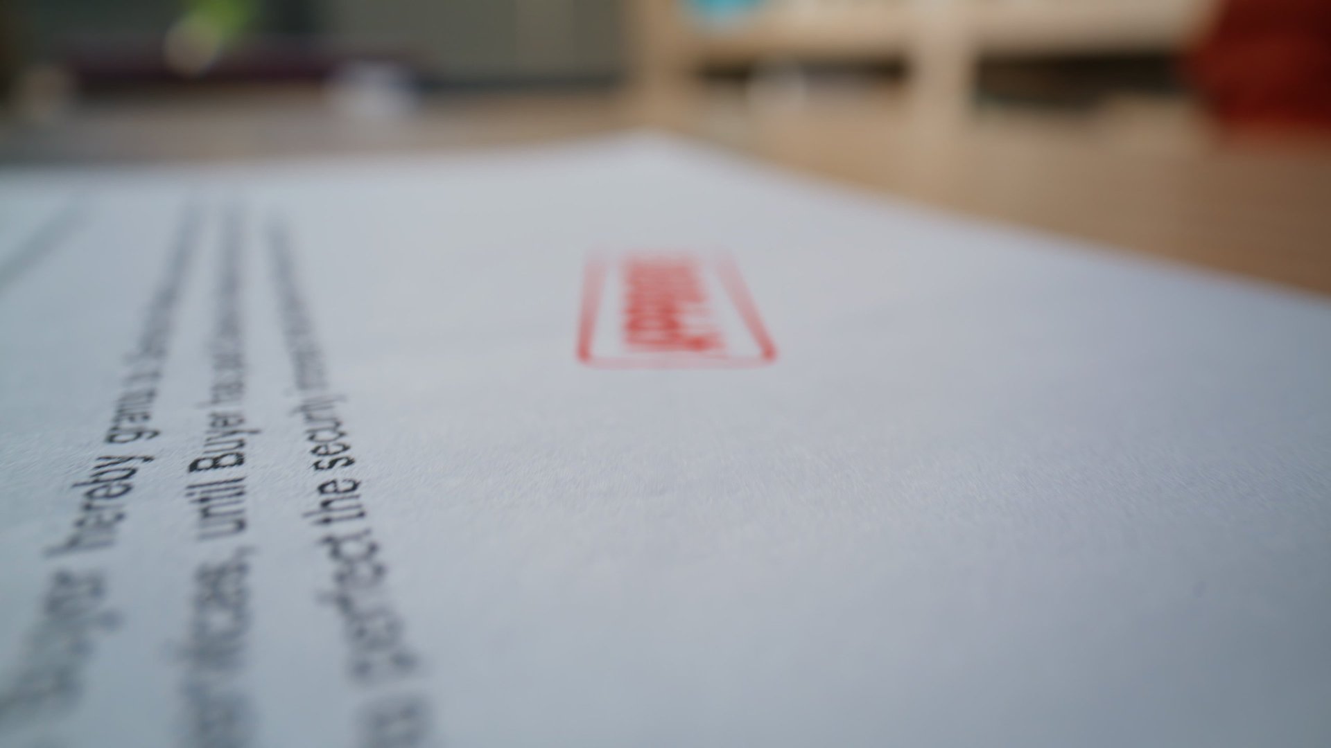 Stamped business document being reviewed on a desk during a documentation check