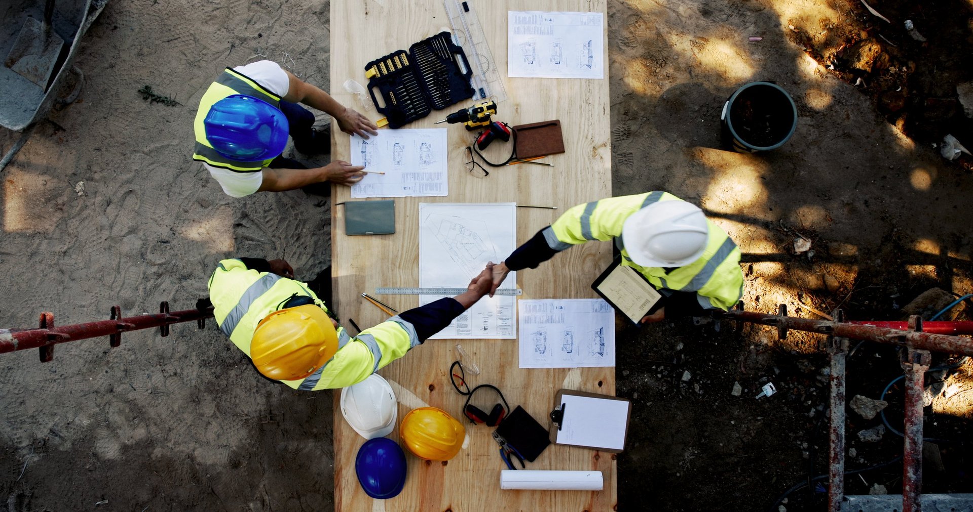 Project team reviewing construction drawings and specifications around a table