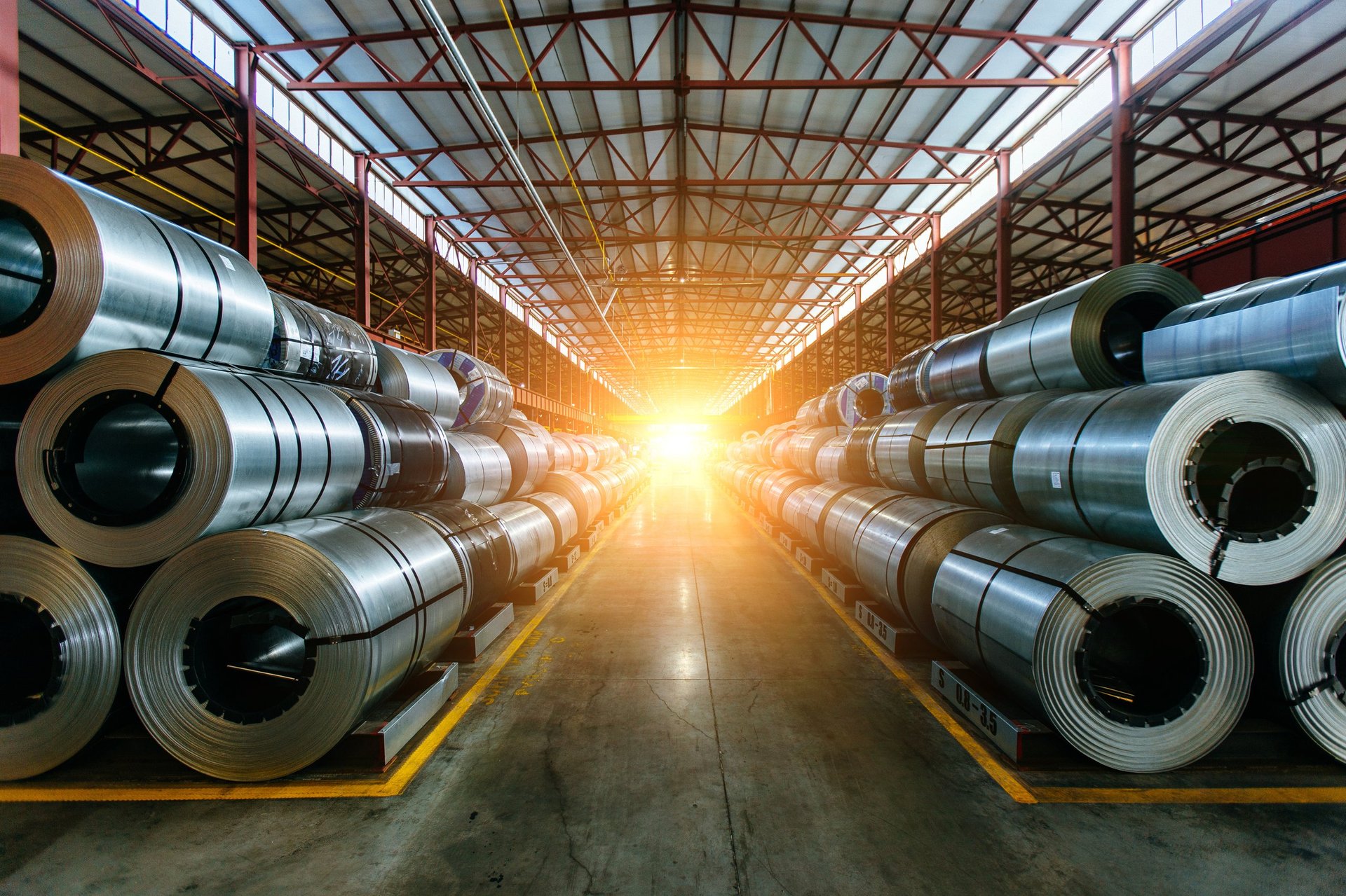 Galvanized steel coils in a professional steel mill, representing the industrial sectors the reports cover.