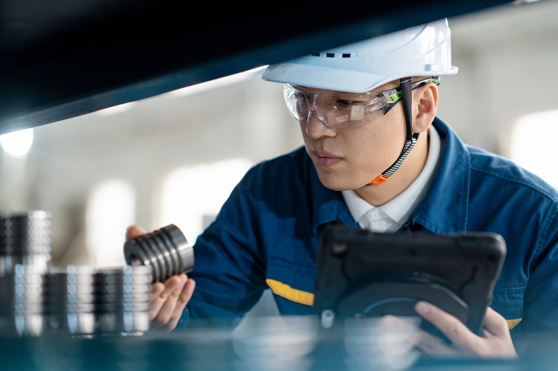Engineer working with measuring equipment on a production line