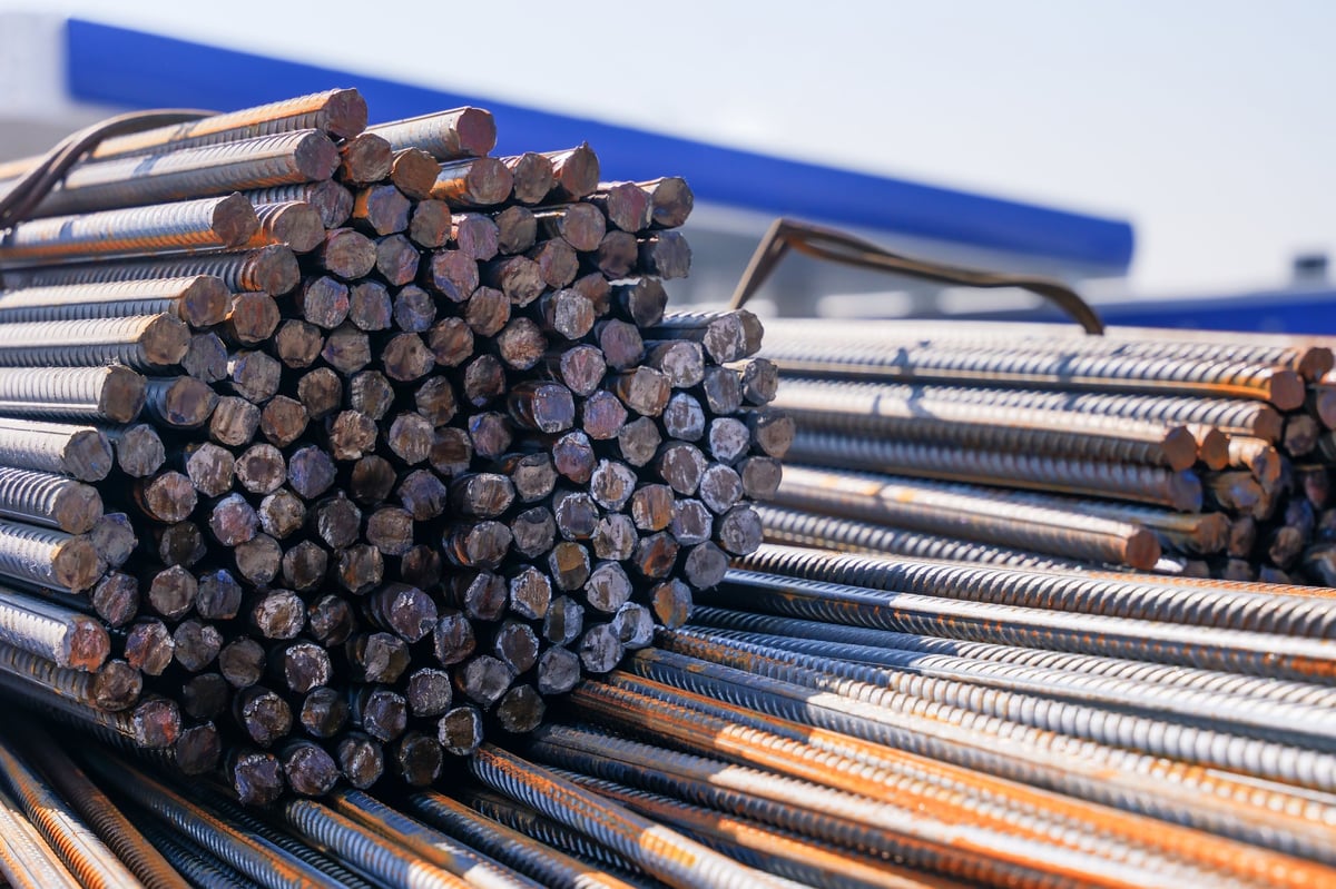 High-strength reinforcing bar bundle with the bar ends presented for size and grade identification review against a mill test certificate.