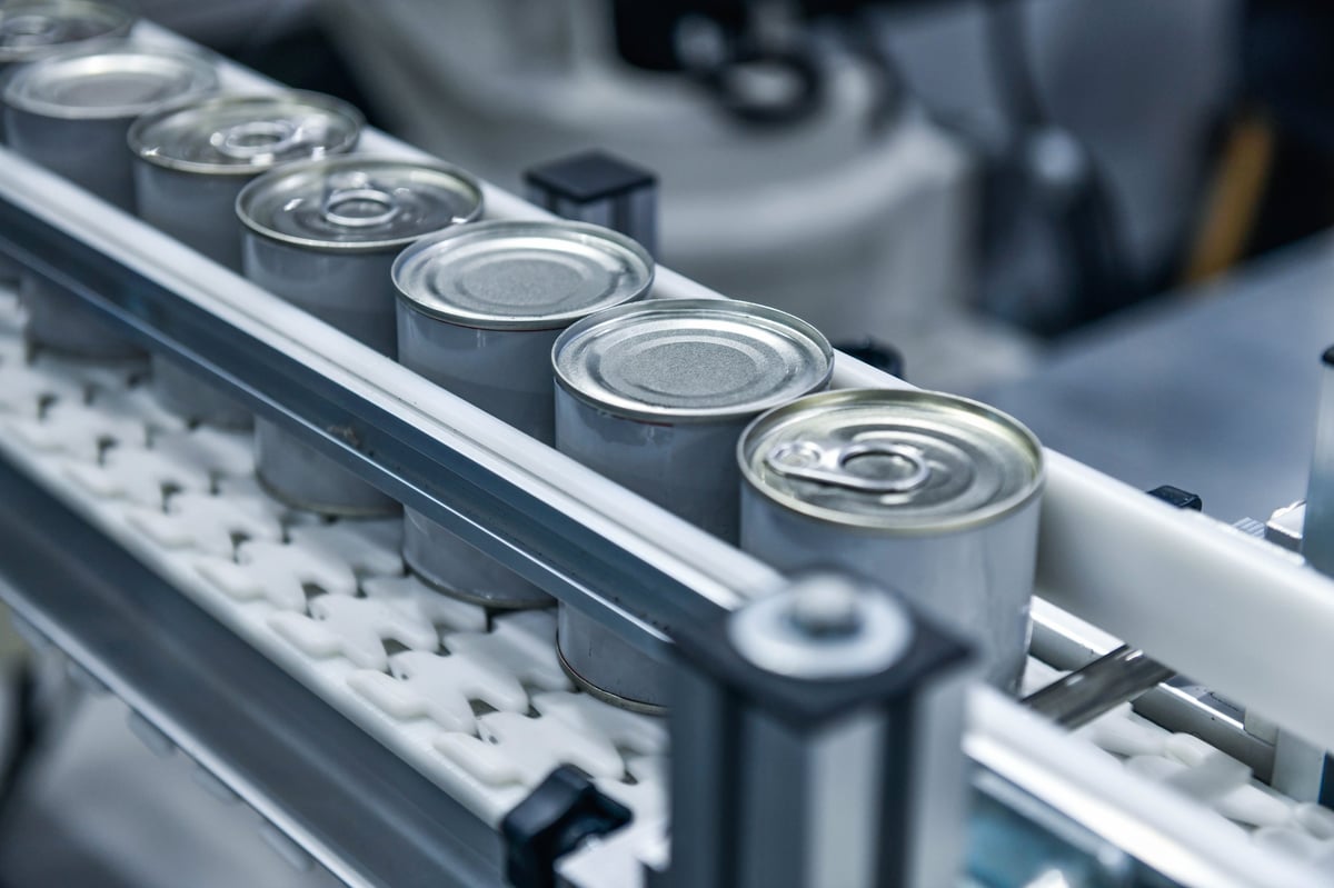 Canned products travelling on a conveyor in a distribution facility