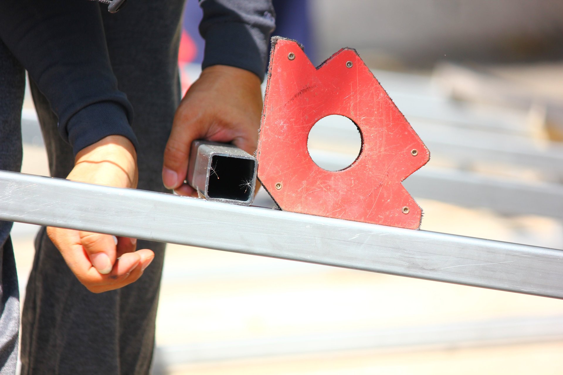 Fabrication workshop preparing rectangular hollow sections for cutting and assembly