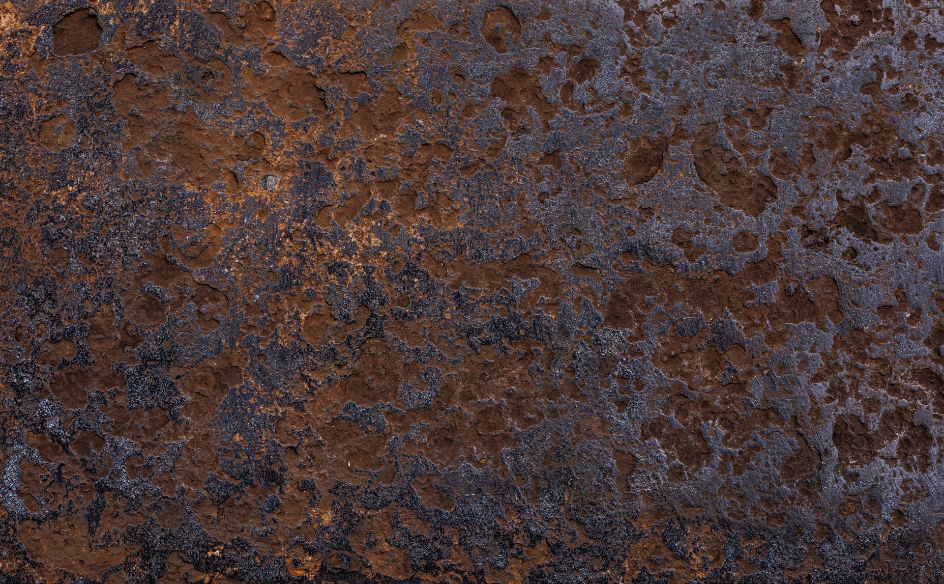 Close view of a weathered steel surface showing the oxide layer that forms over time