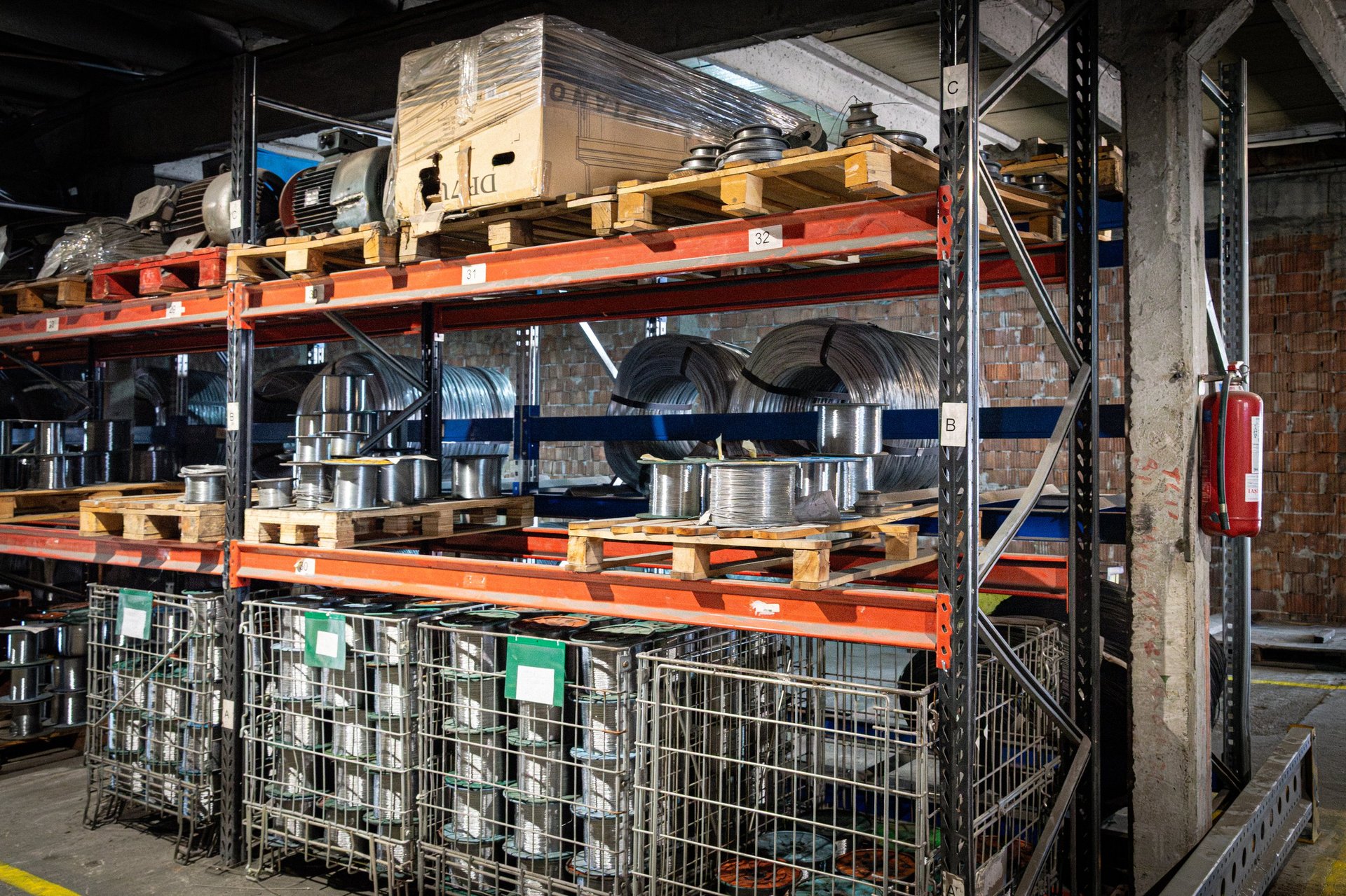 Racked industrial storage holding stacked flat product awaiting despatch