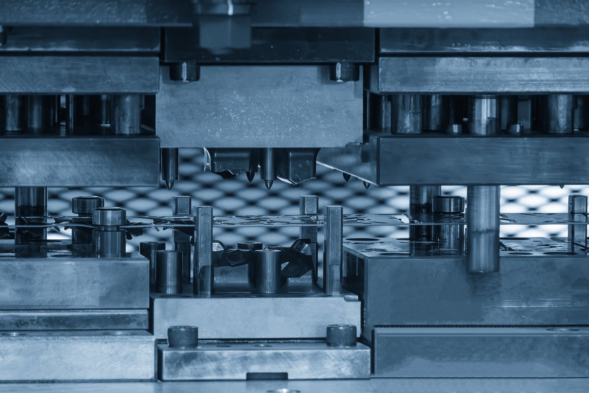Sheet steel being formed through a progressive die press