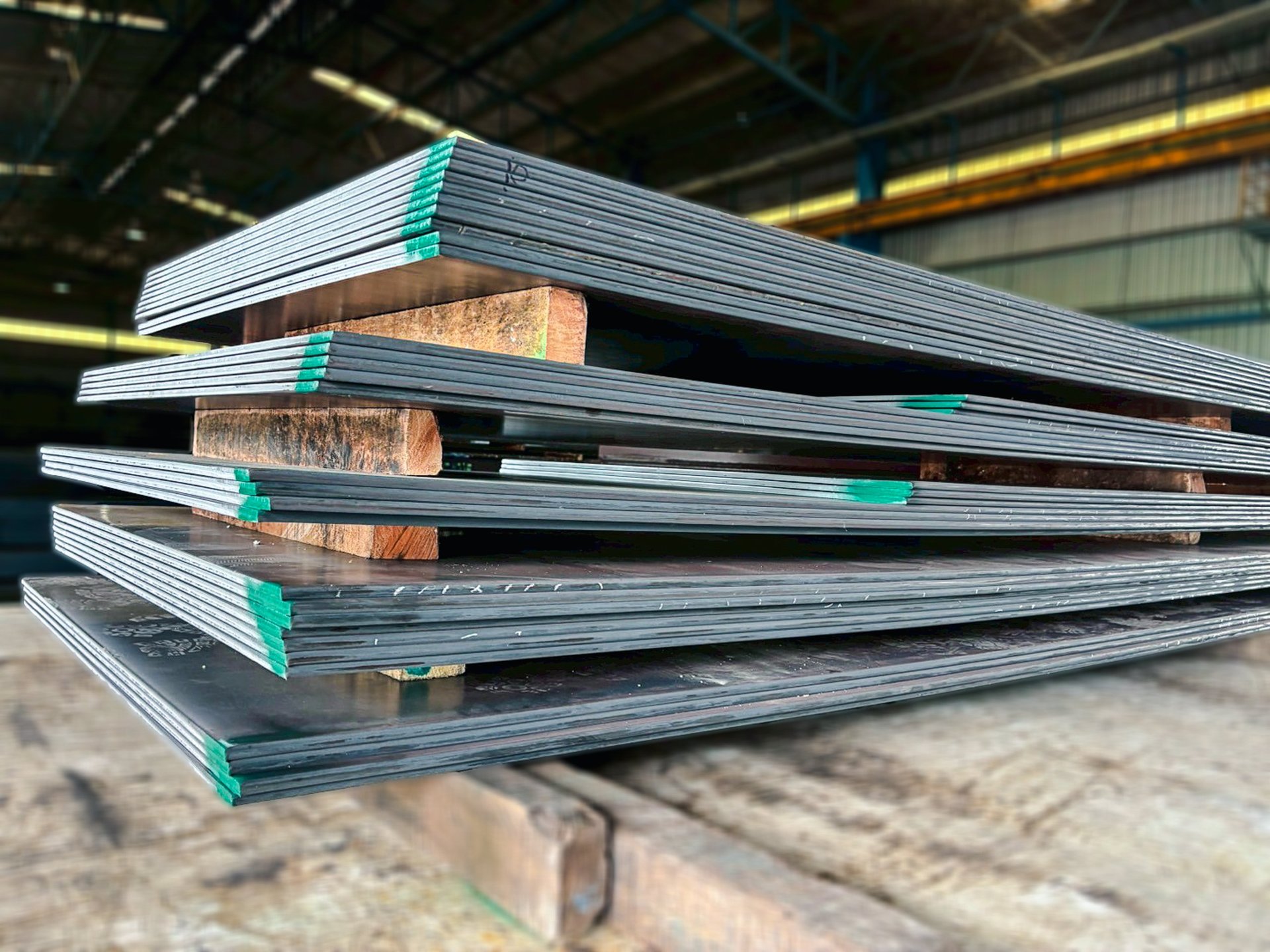 Materials procurement scene showing plate surface and edge inspection