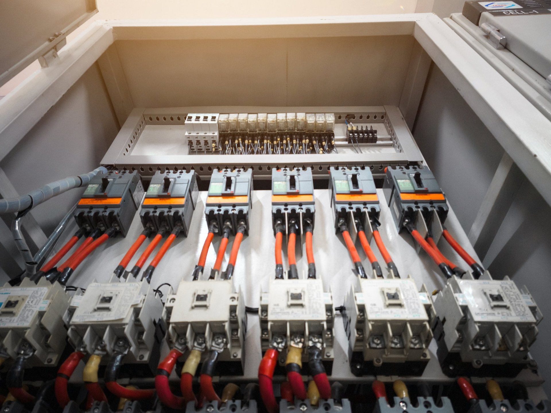 Industrial electrical control panel with circuit breakers and contactors installed in an enclosure