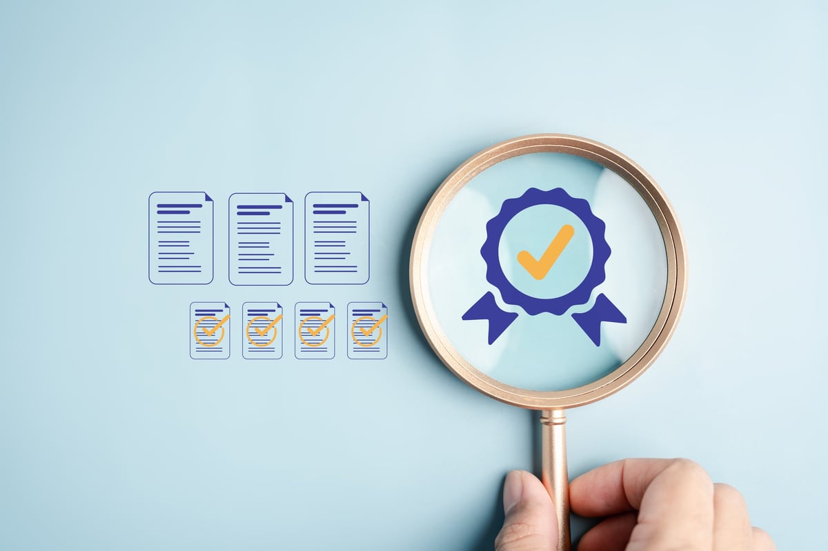 Quality documentation and certification records being checked against an approved standard