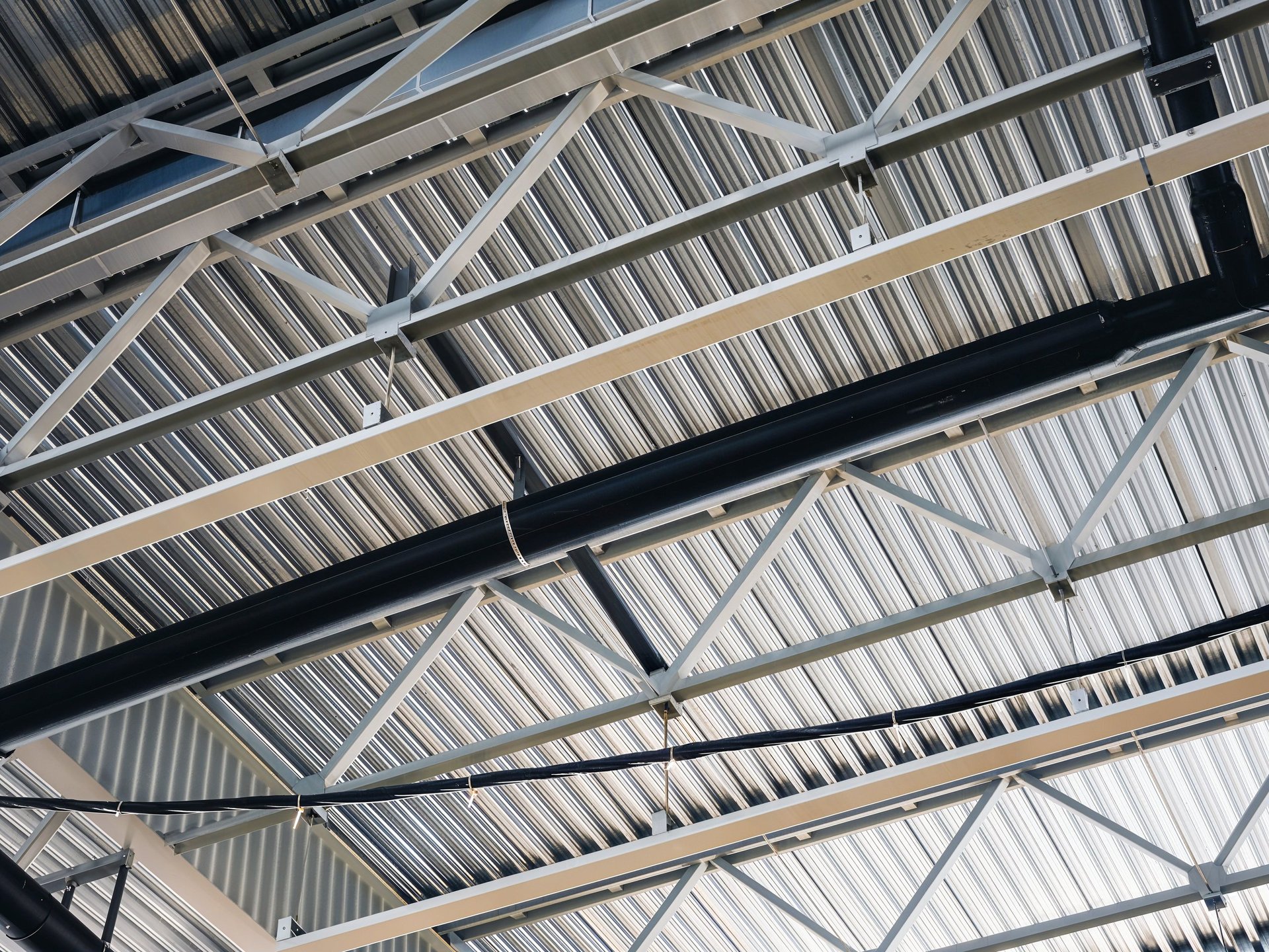 Roof structure showing steel hollow sections and support beams in a fabricated assembly
