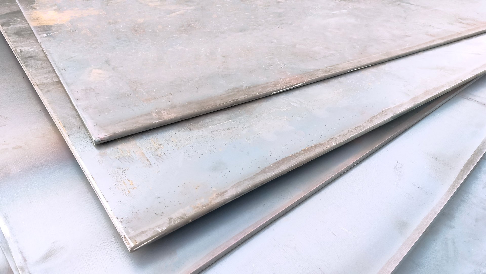 Stack of carbon steel plates ready for cutting in a steel stockyard