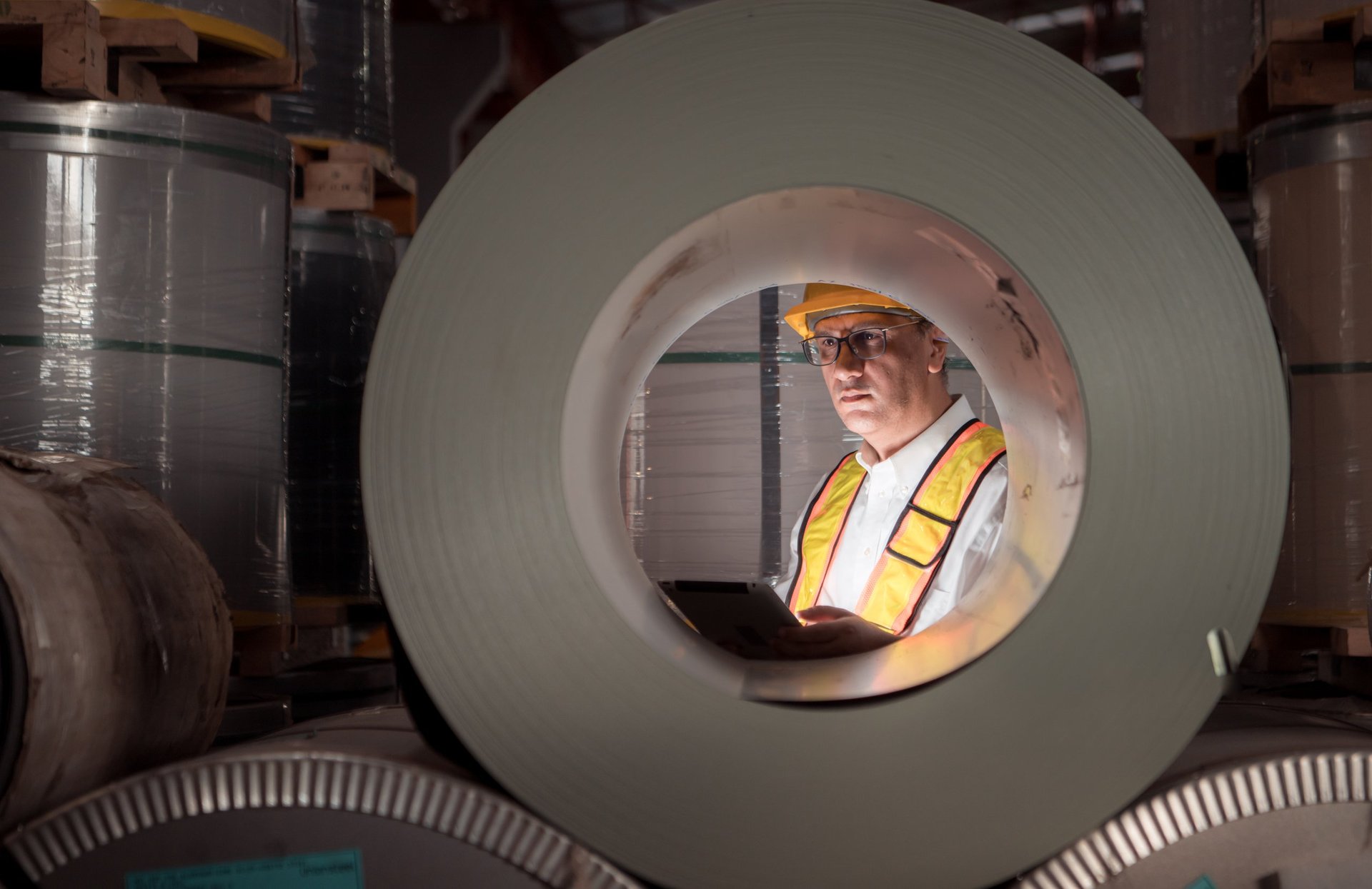 Industrial worker inspecting the inside of a large metal component