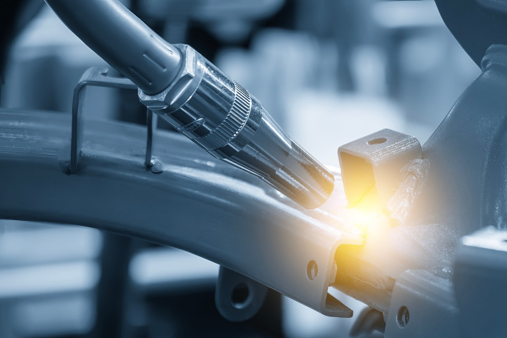 Automated welding robots assembling metal components on a production line