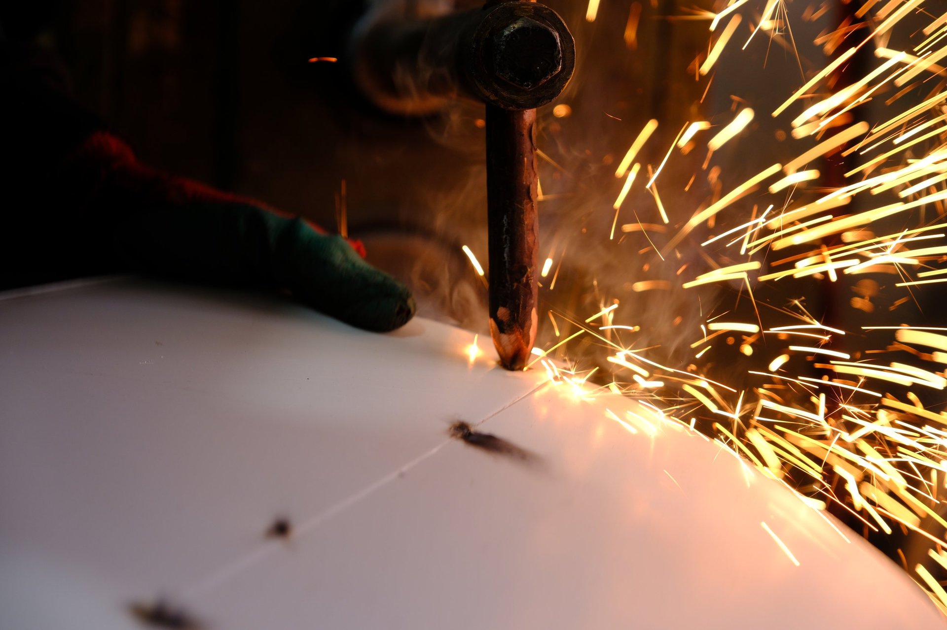 Inspector checking steel sheet certification and lot identification against a consignment