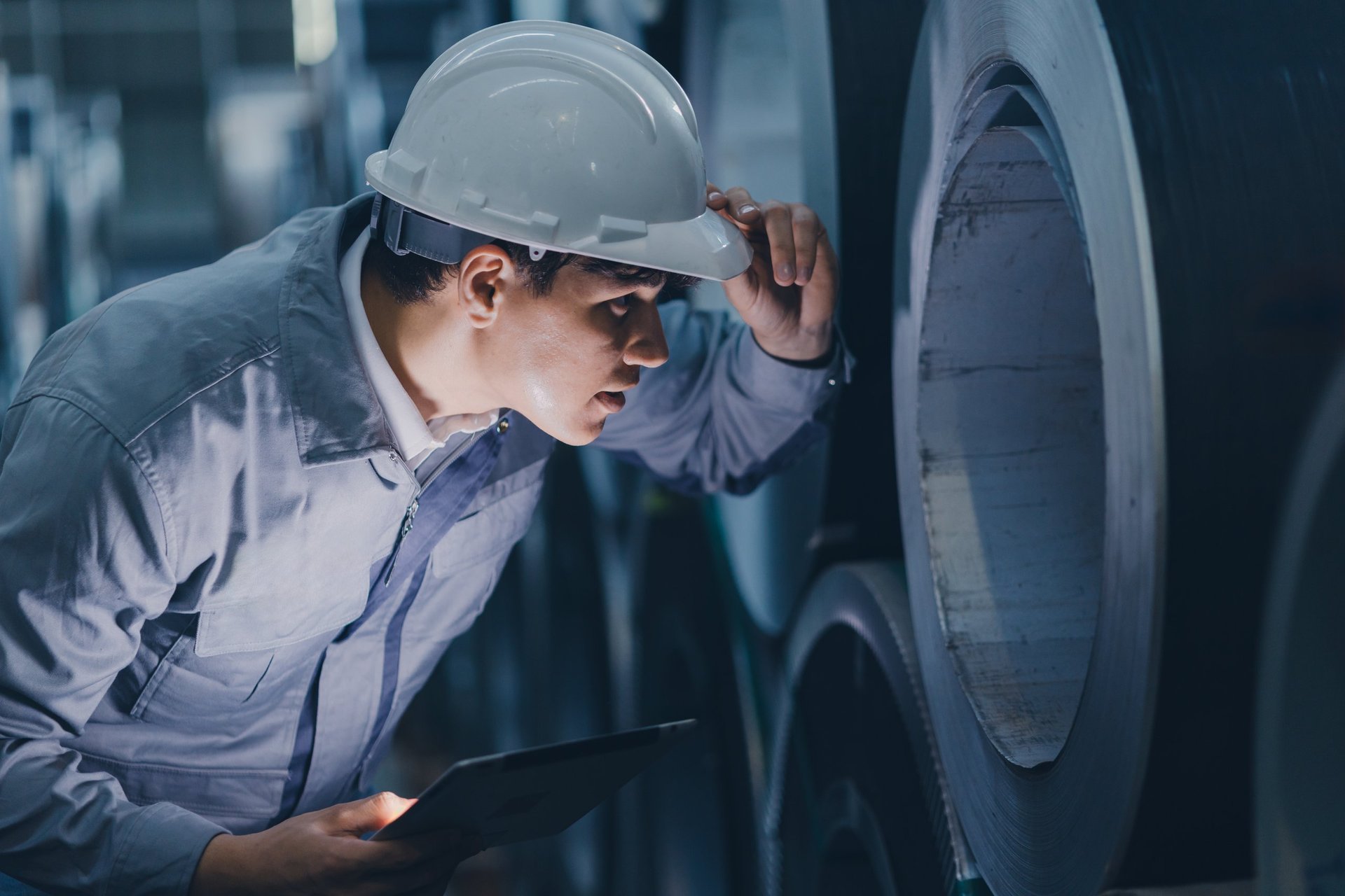 Engineer inspecting a shipbuilding steel plate against the governing standard
