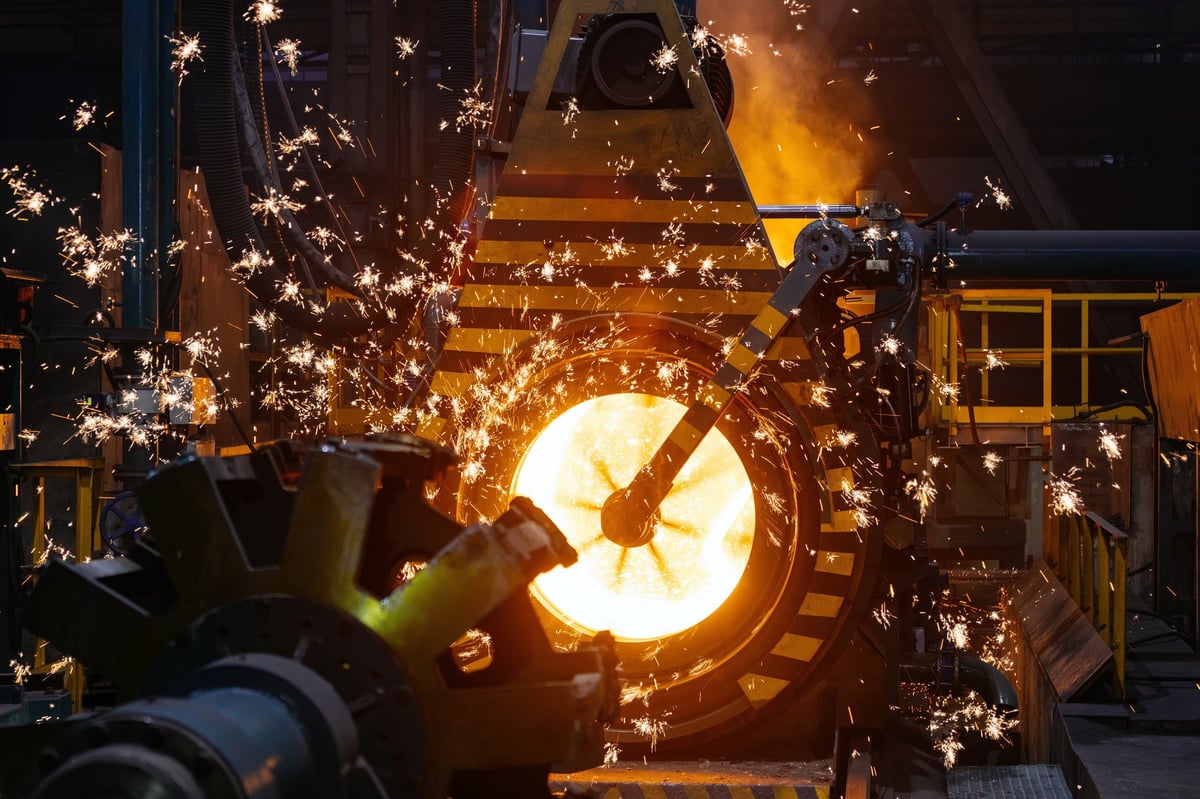 Freshly cast iron at a foundry, the downstream step a hydrated ore's water content finally leaves the material.
