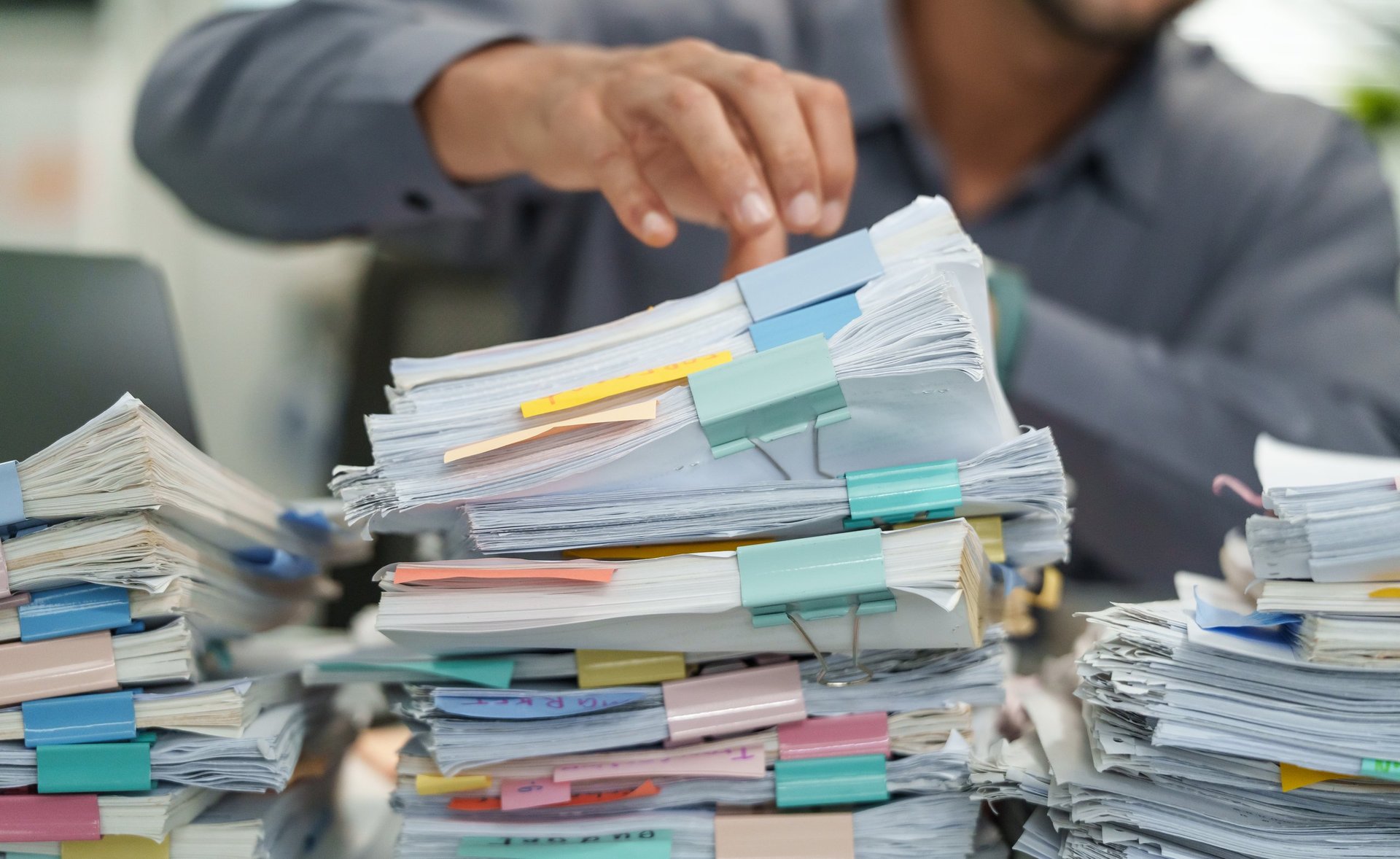 Desk work surface with technical documents and reference files being arranged for review