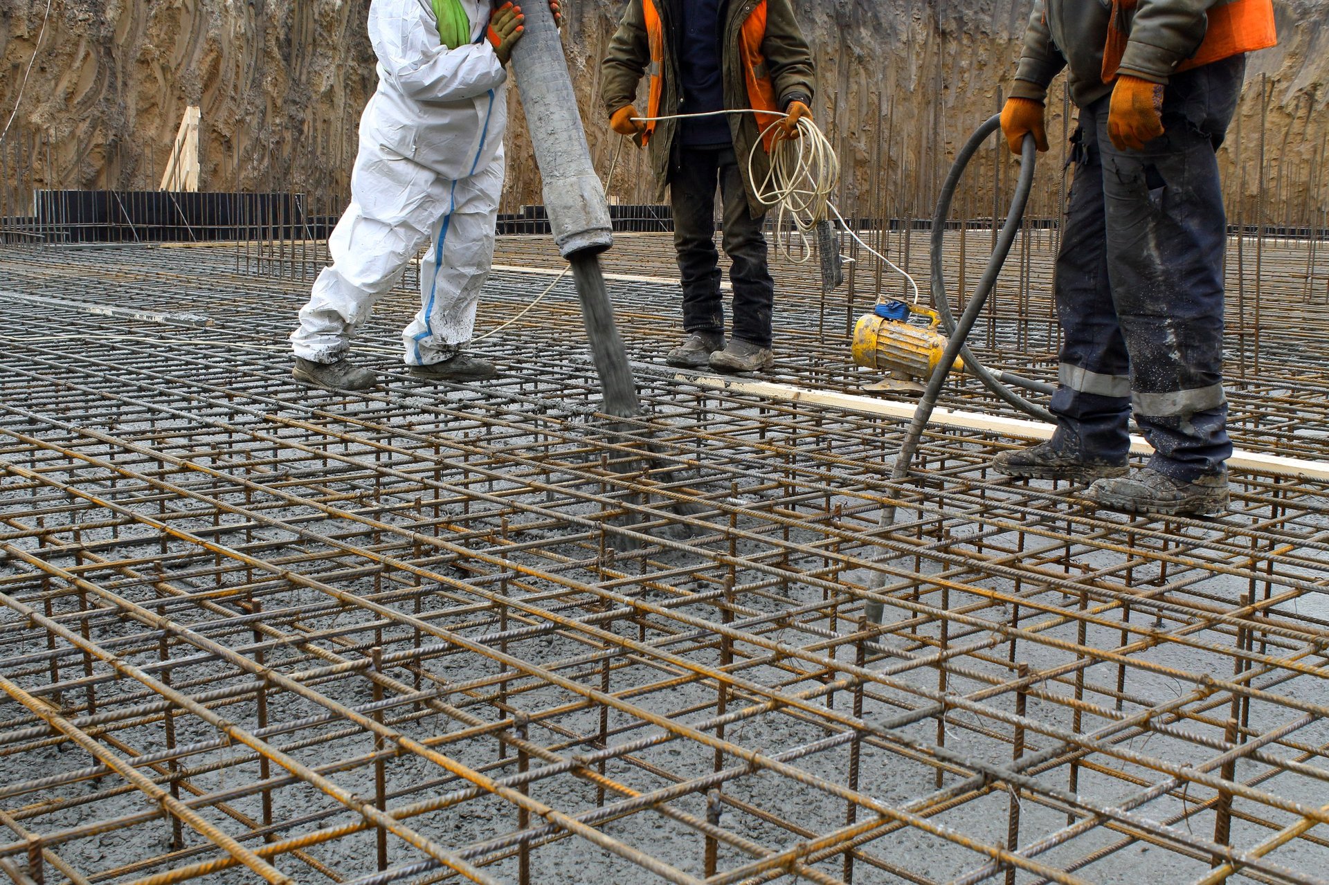 Concrete Reinforcement Bar — approved reinforced-concrete slab drawing placed beside matching bar marks and a staged reinforcement mat.