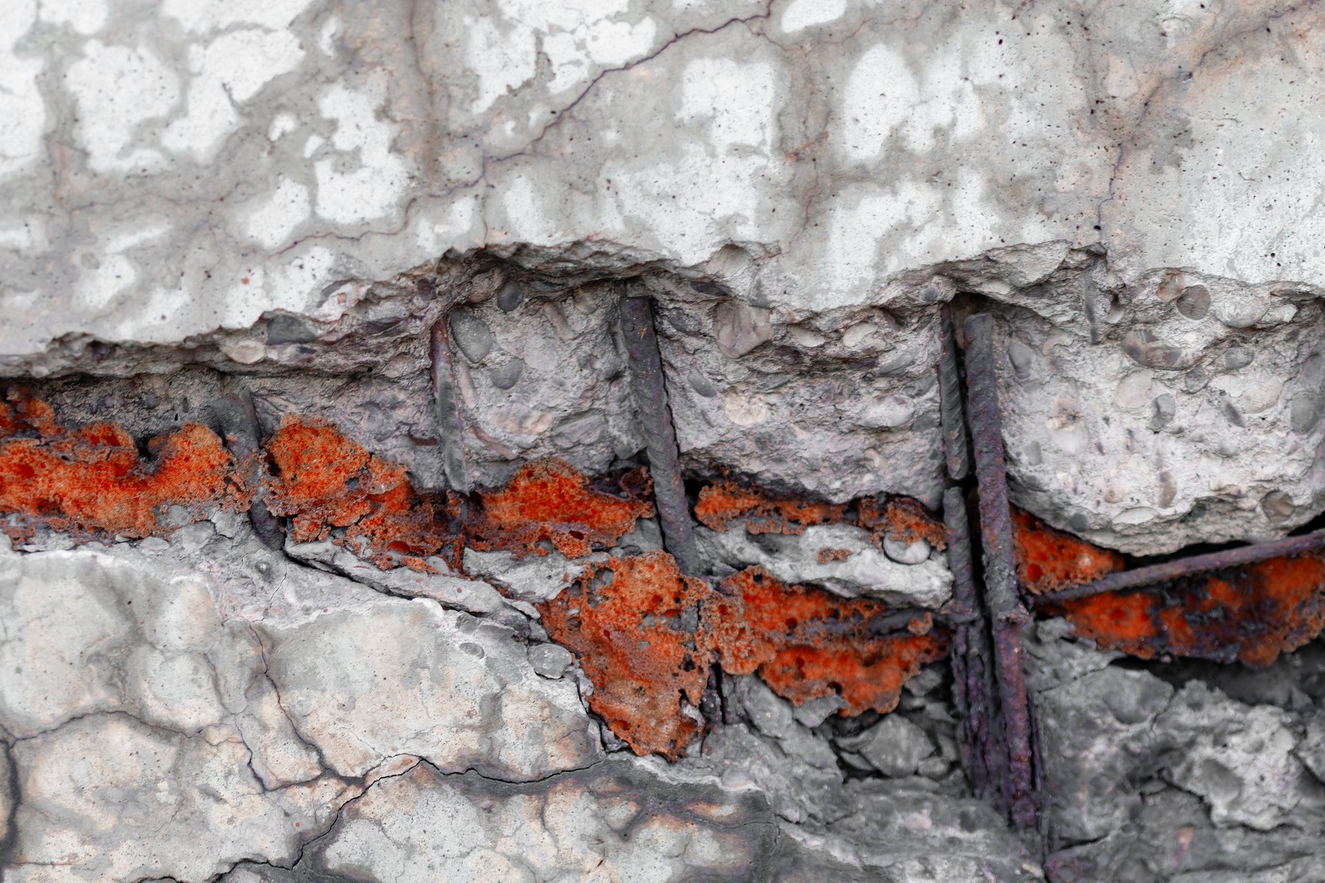 Deteriorated concrete edge exposing corroded reinforcement bars in a marine environment