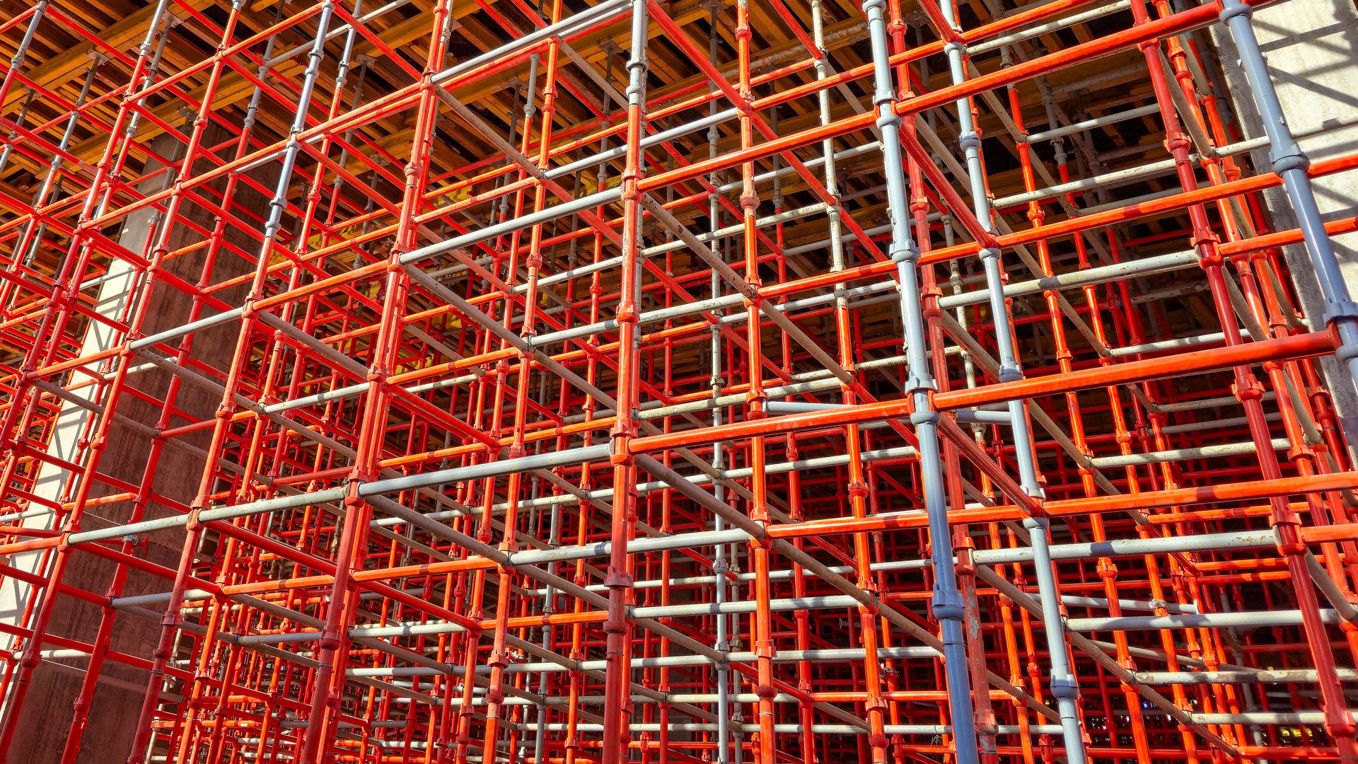 Metal scaffolding structure frame with tubes and couplers at an industrial site