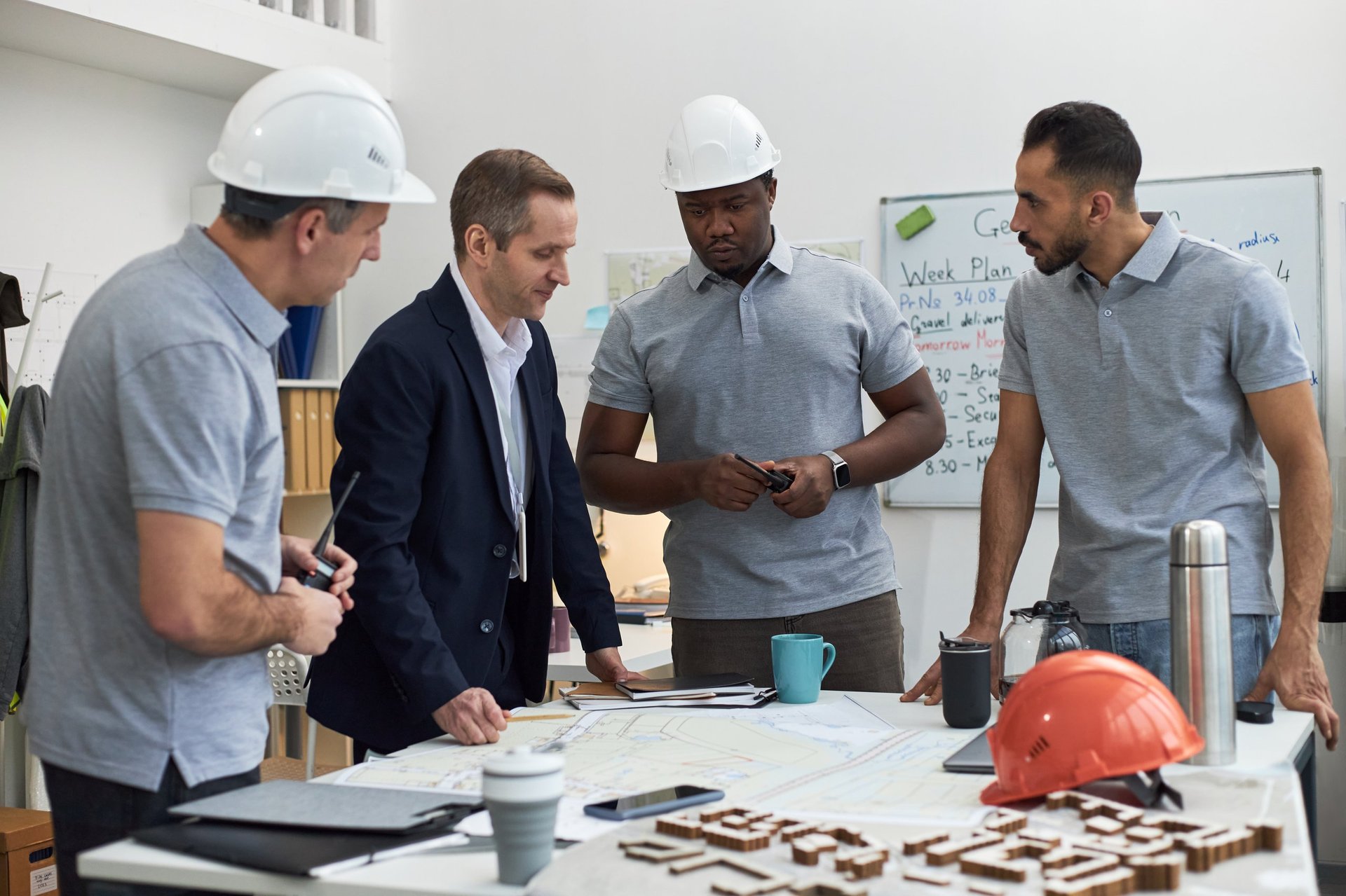 Project team reviewing construction drawings and specifications around a table