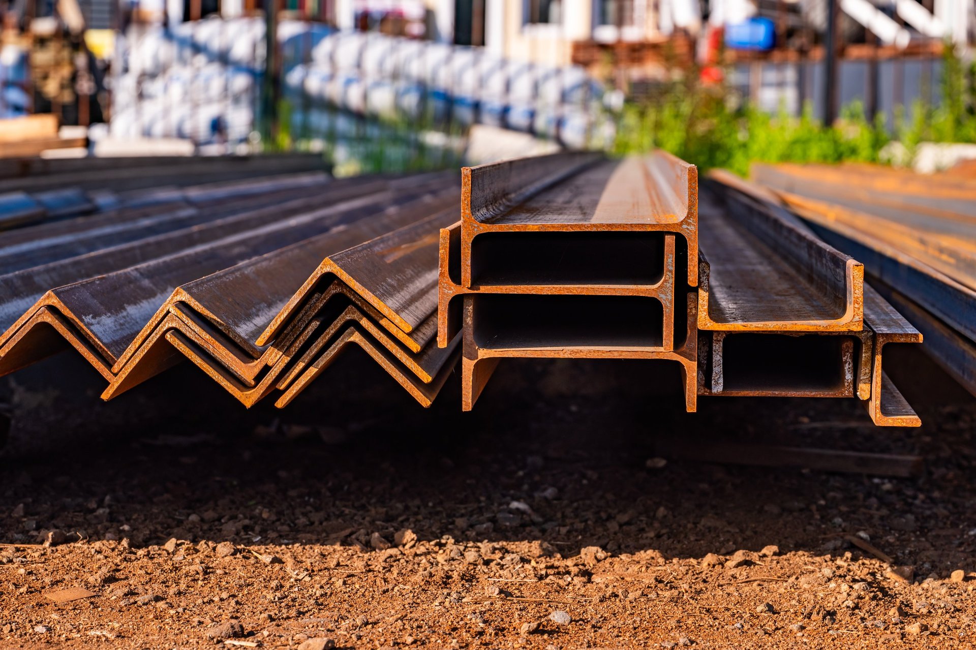 Structural steel profiles and I-beams staged in a construction yard
