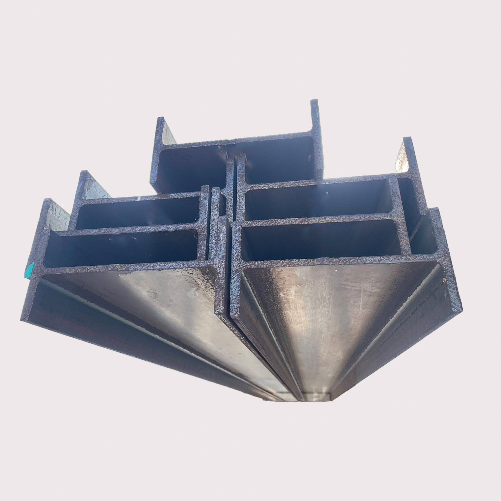 Stacked wide-flange H beam sections awaiting inspection before dispatch