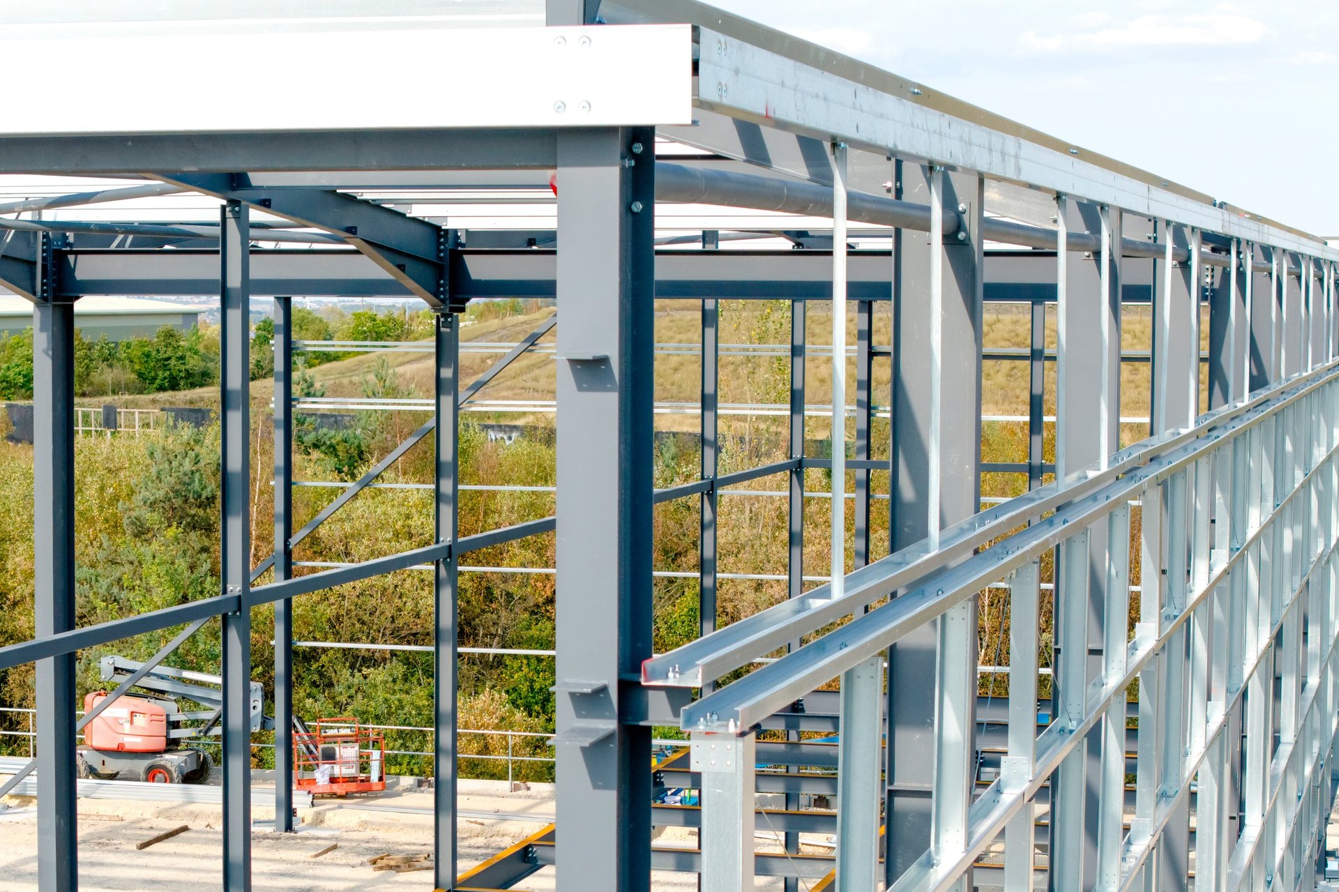 Workers assembling a steel framework on an industrial construction site