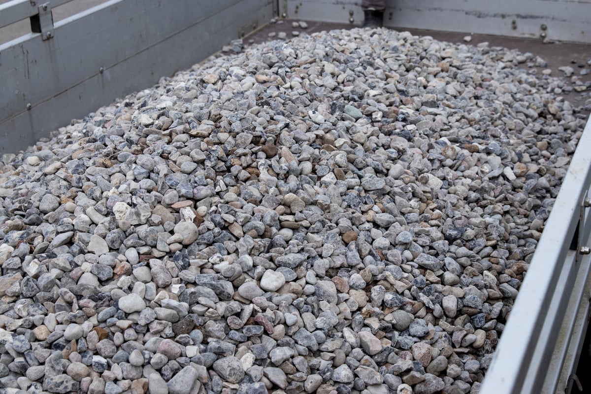 Close view of bulk material showing a mix of particle sizes and shapes in a loading bed.