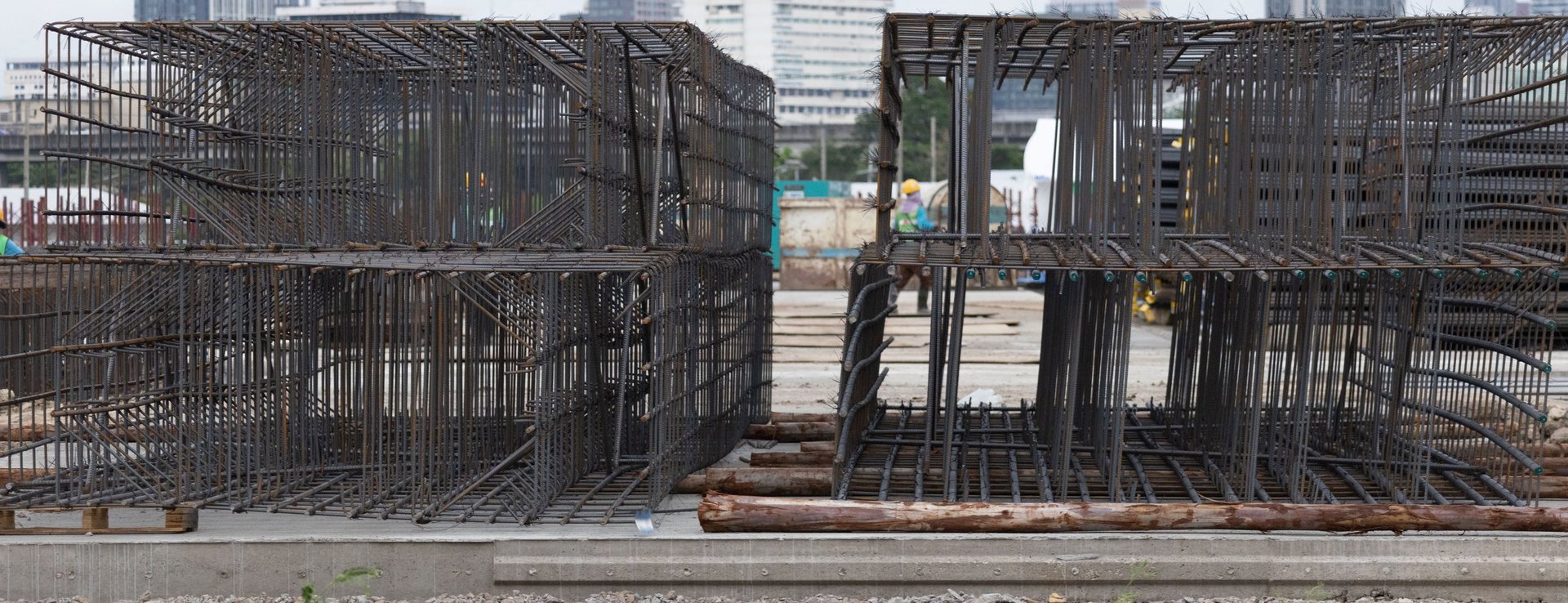Foundation Rebar — steel rebar cages staged and ready for concrete pouring, arranged for foundation pour-zone sequencing and traceability.