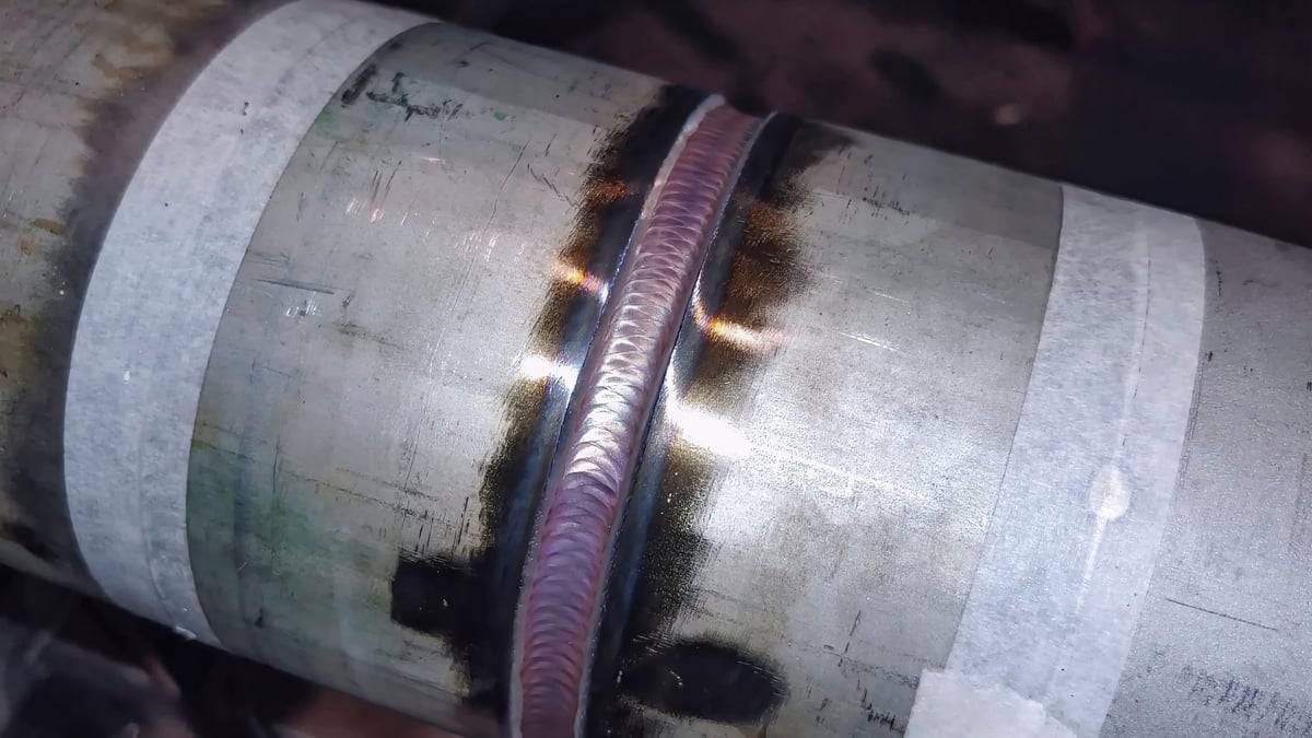 Welding the seam of a steel pressure pipe at a fabrication works