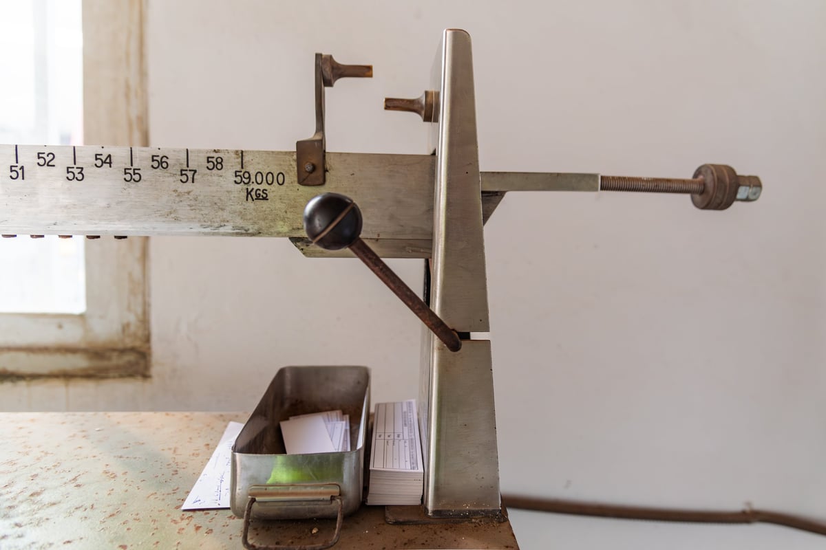 A mechanical weighbridge scale with its balance arm being adjusted, used to establish tonnage.
