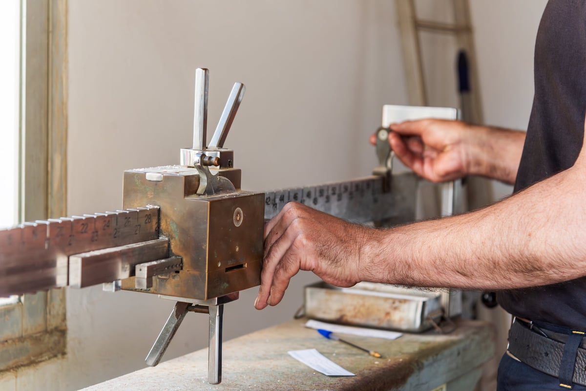 150 × 150 mm square billet end face measured with a large digital caliper.