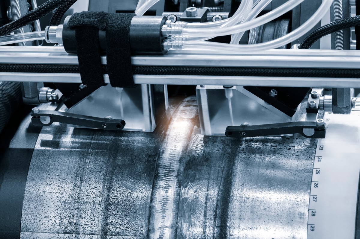 Radiographic and ultrasonic inspection equipment testing a weld on a large-diameter pipe
