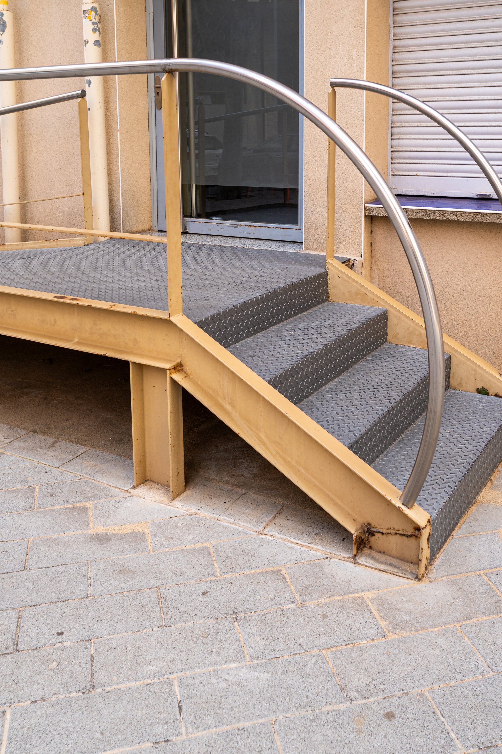 Painted steel handrails and balustrades along an external staircase