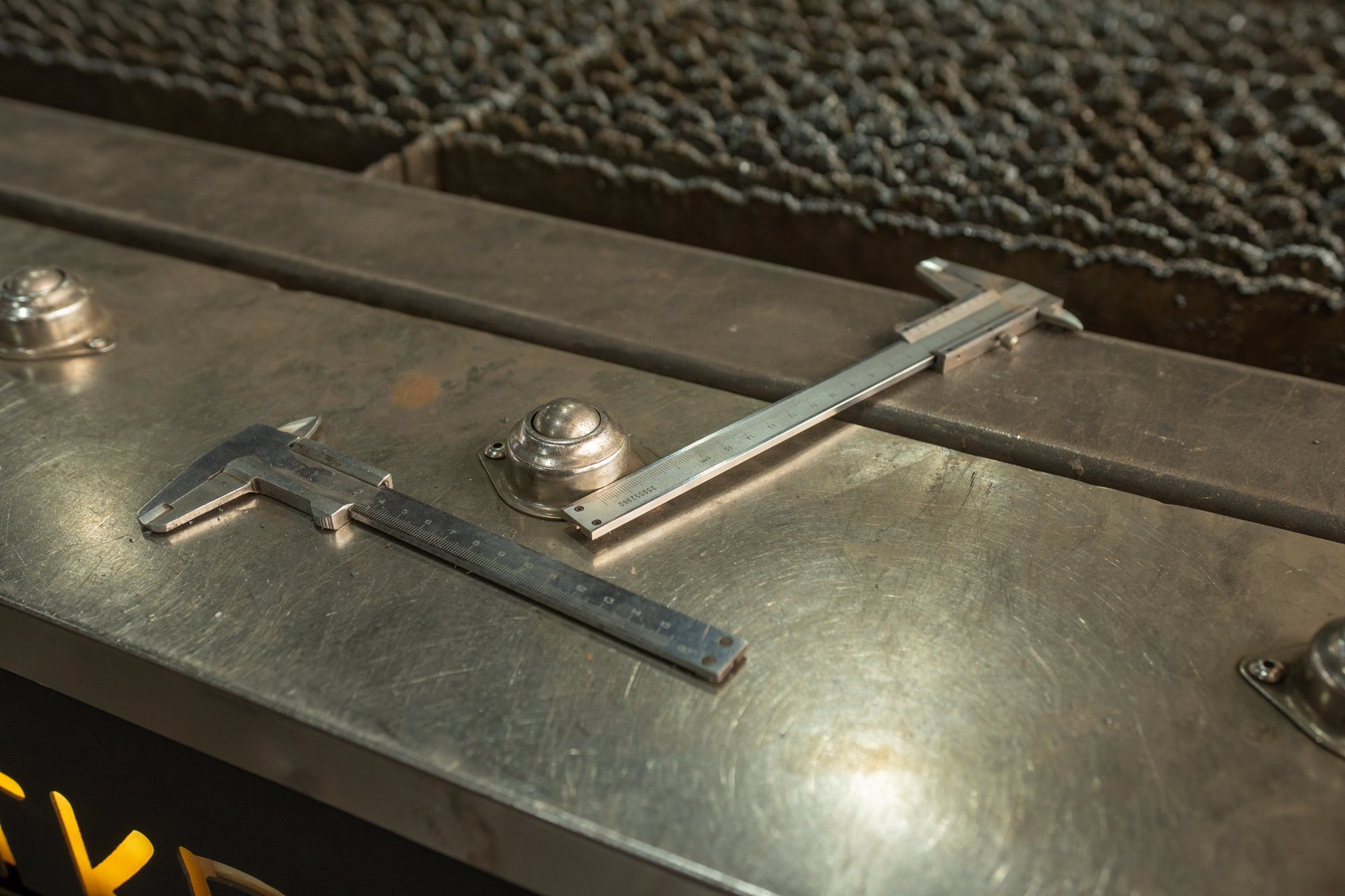 Precision measurement tools on a steel inspection surface for member specification review