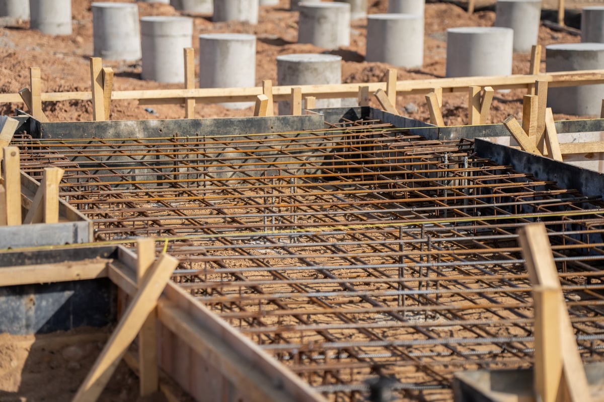 Reinforcement cage placed inside concrete slab formwork with bracing visible, illustrating the confined and congested conditions where anchorage and bend checks bind.