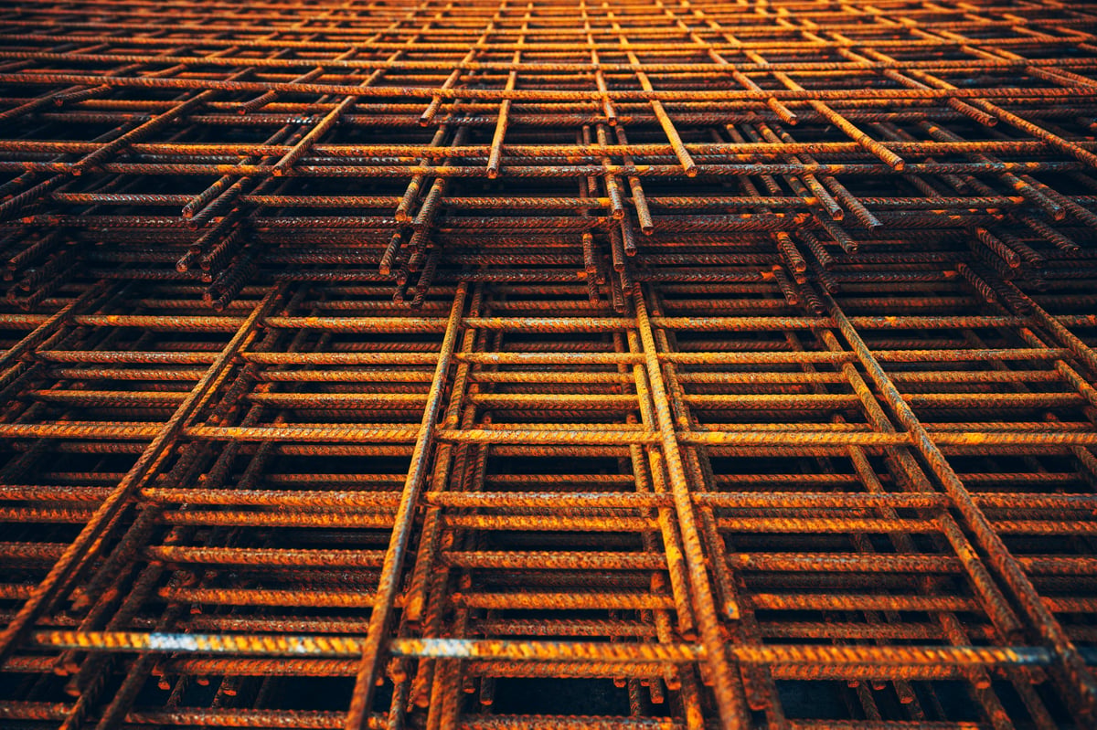 Stacked reinforcement mesh showing the repeating bar pattern, illustrating the scheduled reinforcement whose class and size requirements must match the drawing.